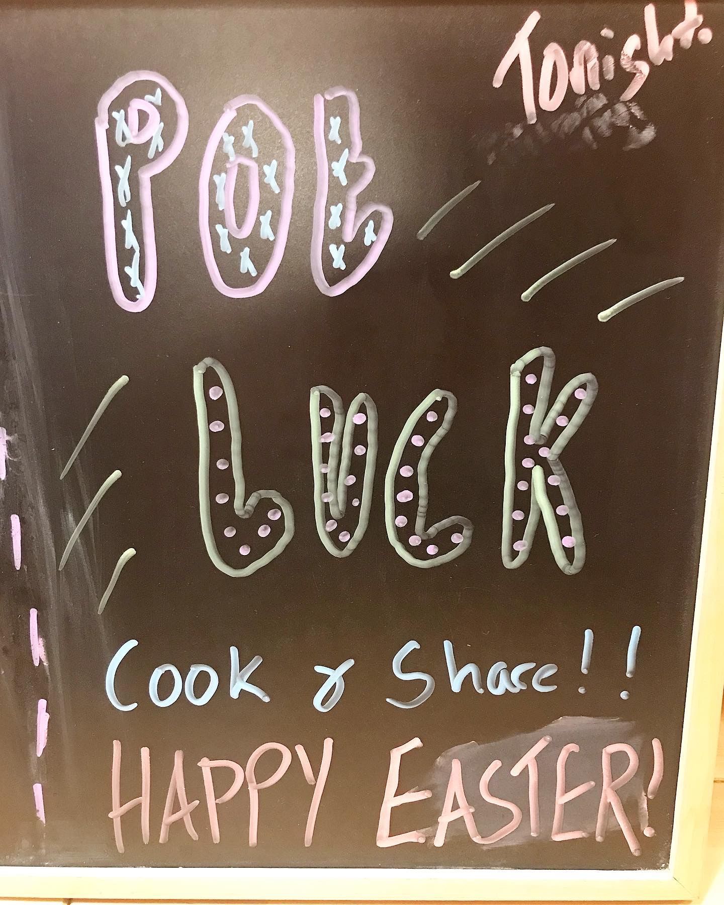 A blackboard with the words luck cook and share written on it
