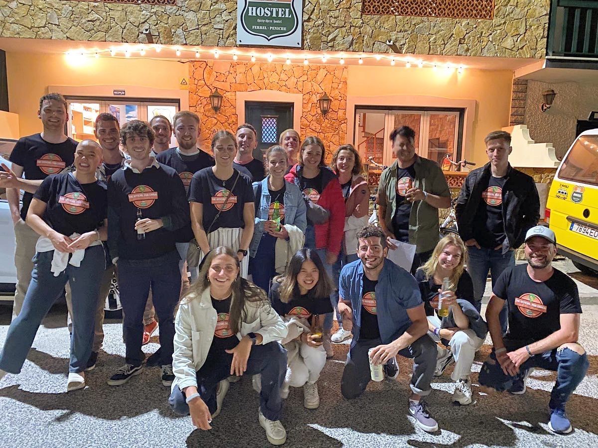 A group of people are posing for a picture in front of a building.