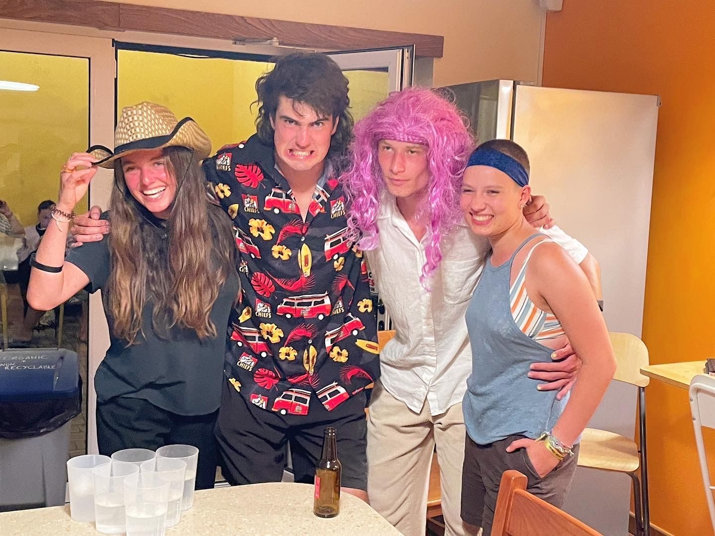 A group of people are posing for a picture in a room.