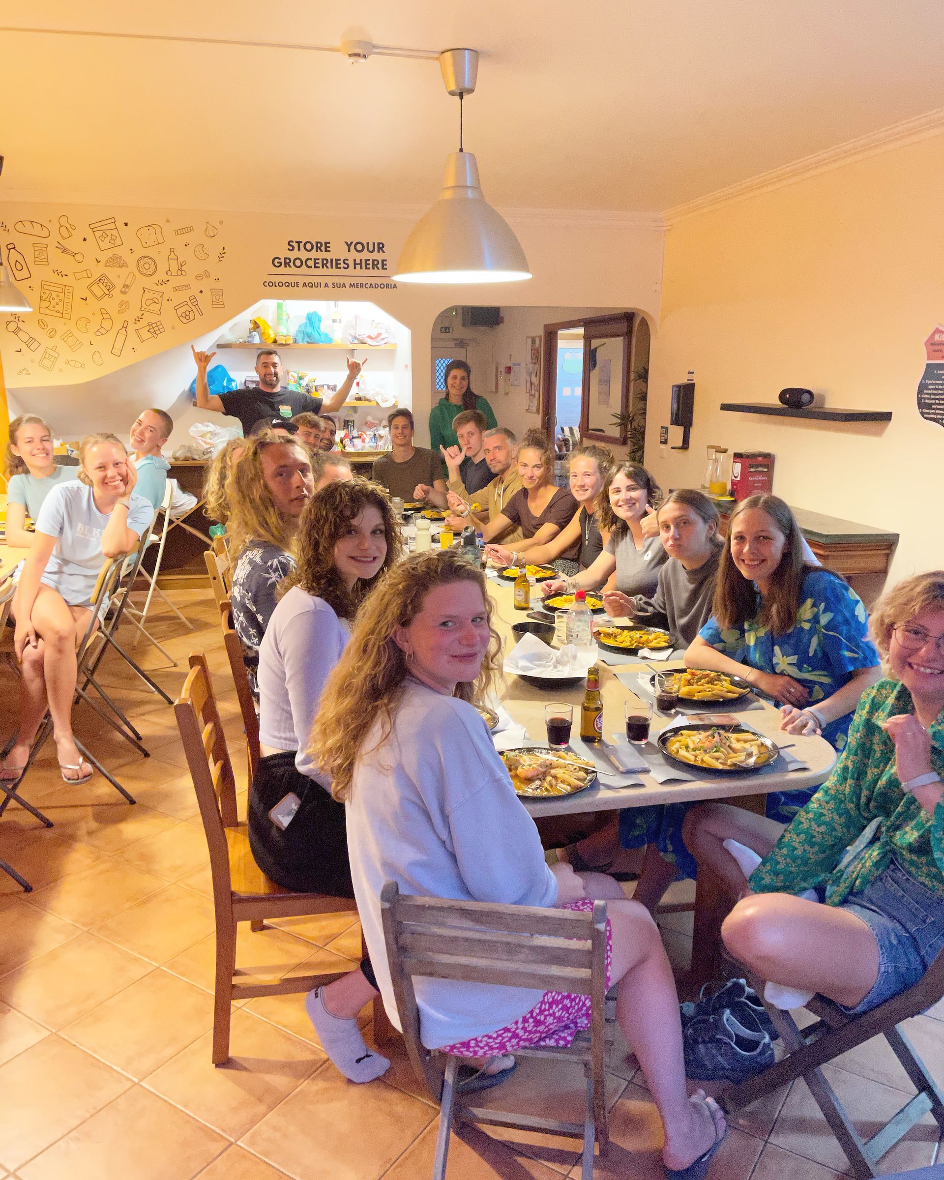 A group of people are sitting around a table with plates of food