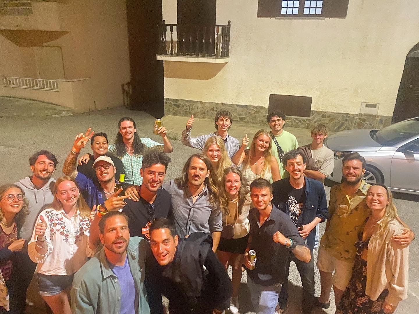 A group of people are posing for a picture in front of a building.