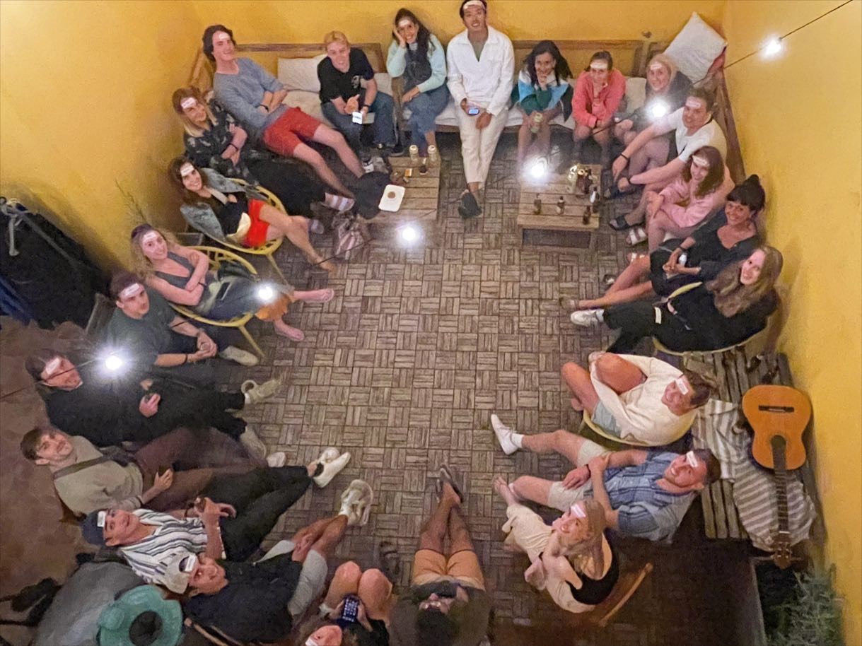 A group of people are sitting in a circle in a room.