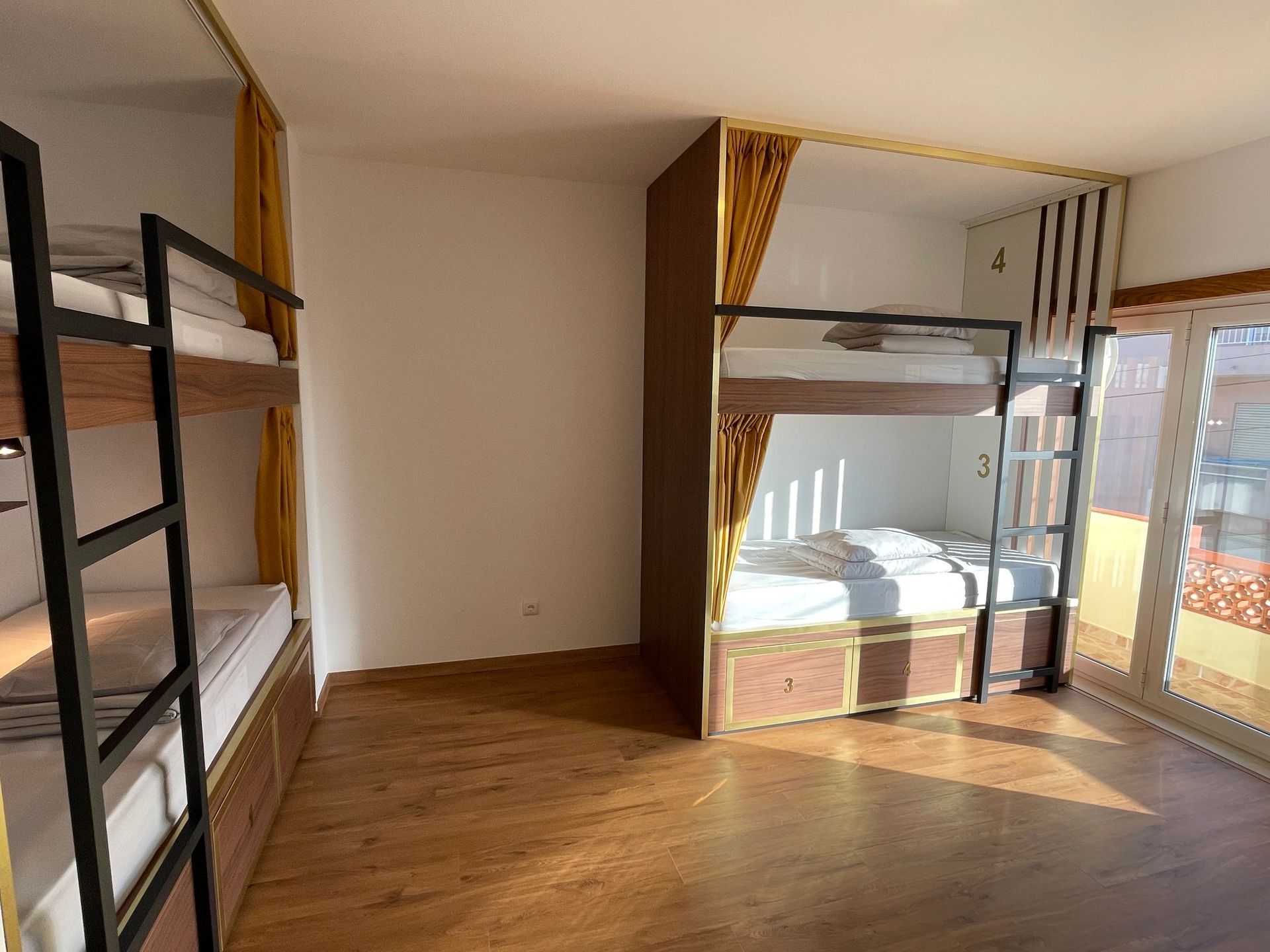 A room with bunk beds and a ladder in it.