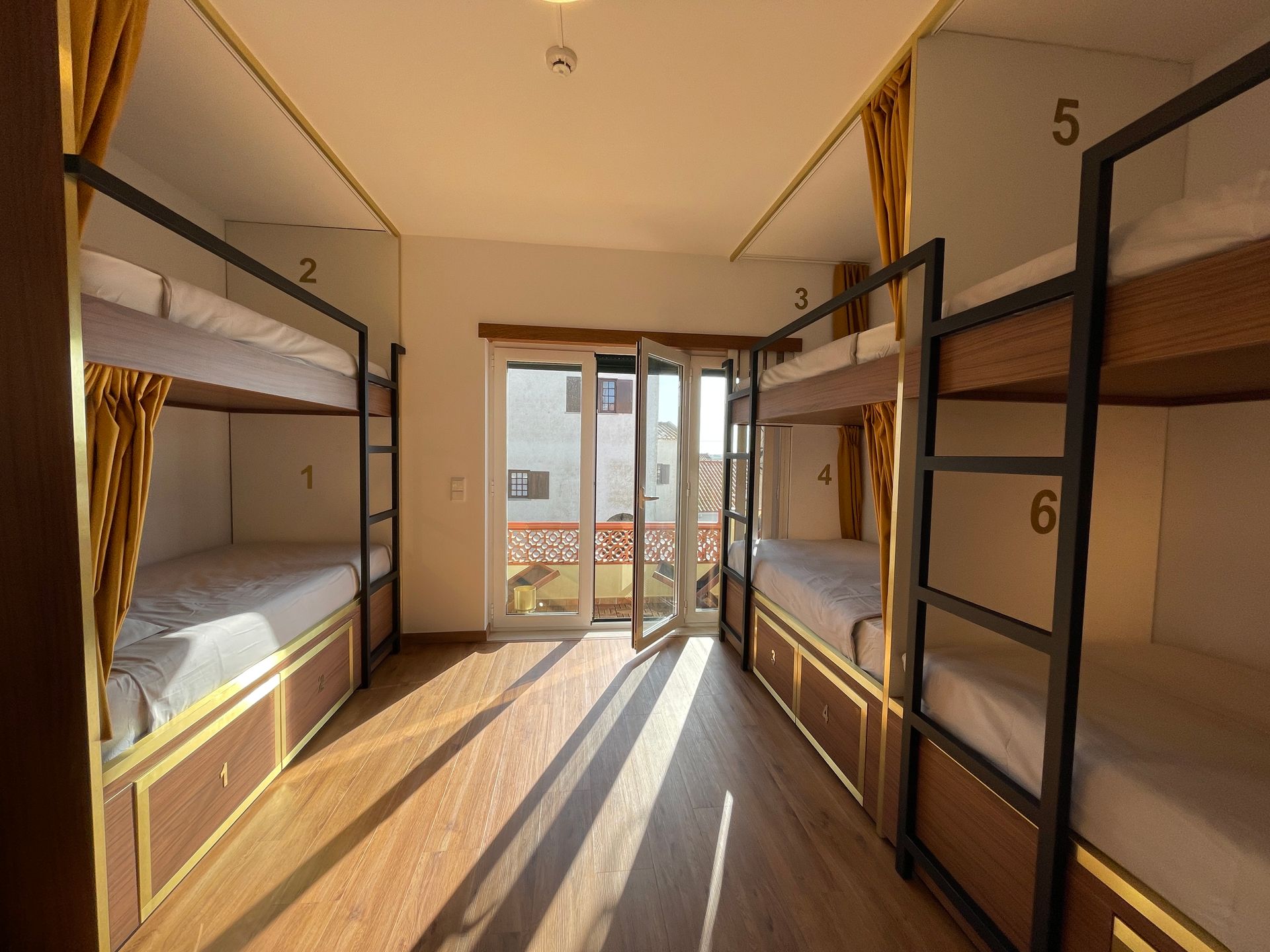A room filled with bunk beds and a window.