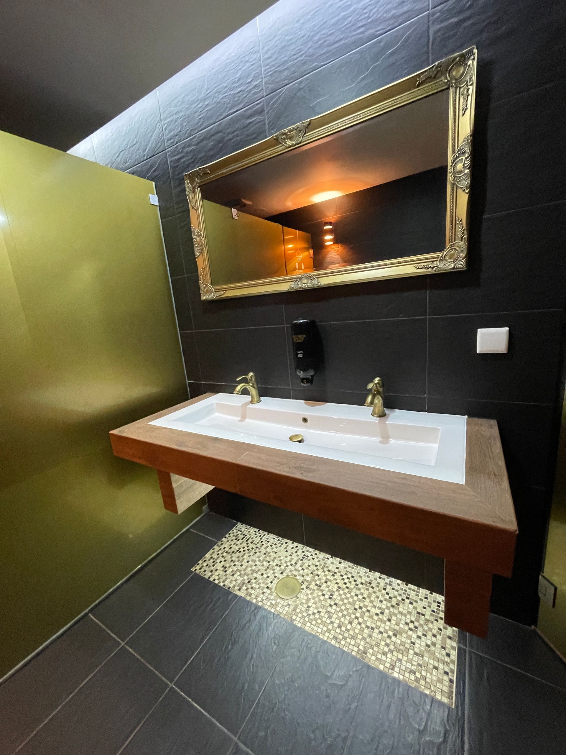 A bathroom with two sinks and a large mirror