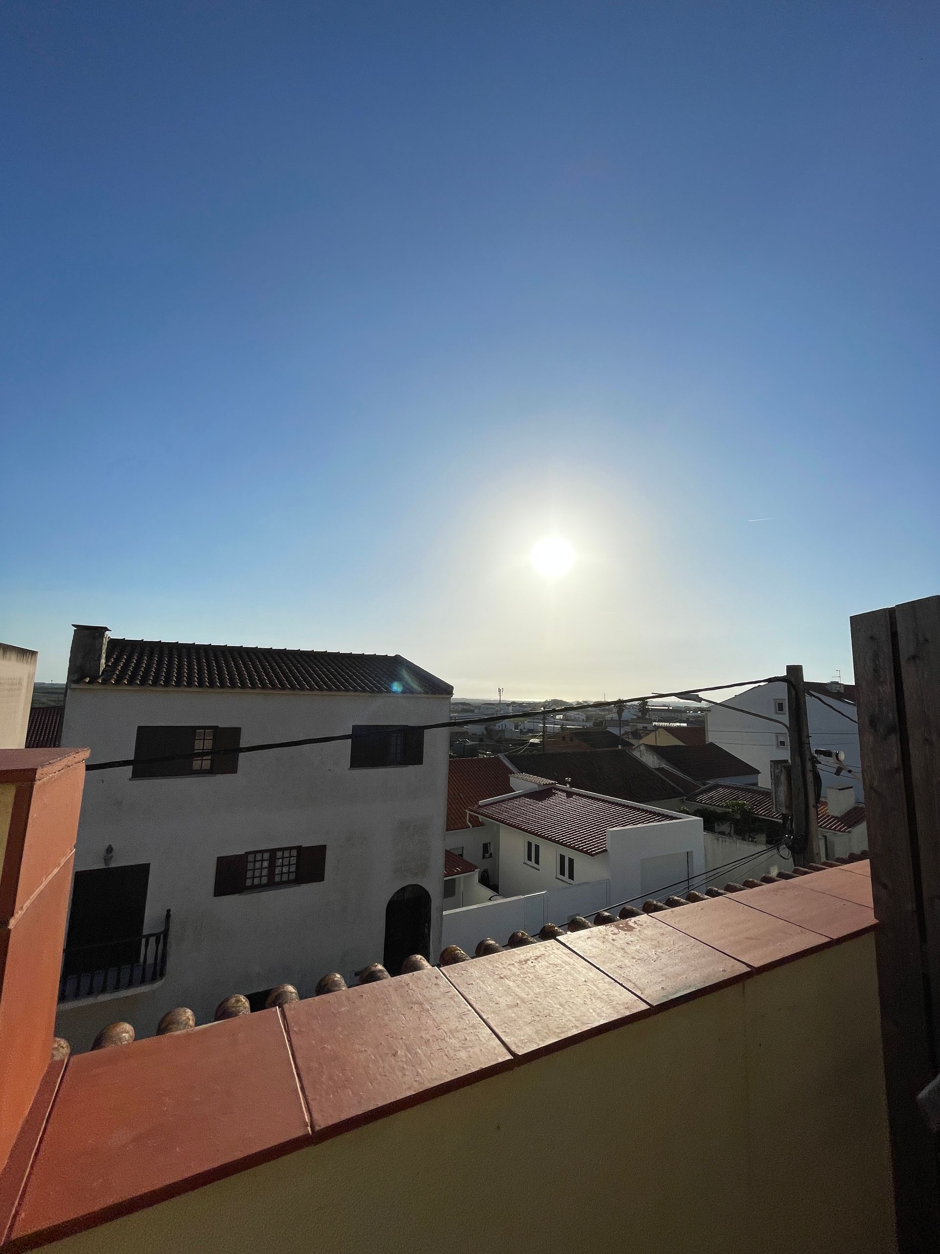 A view of a city with the sun shining through the buildings