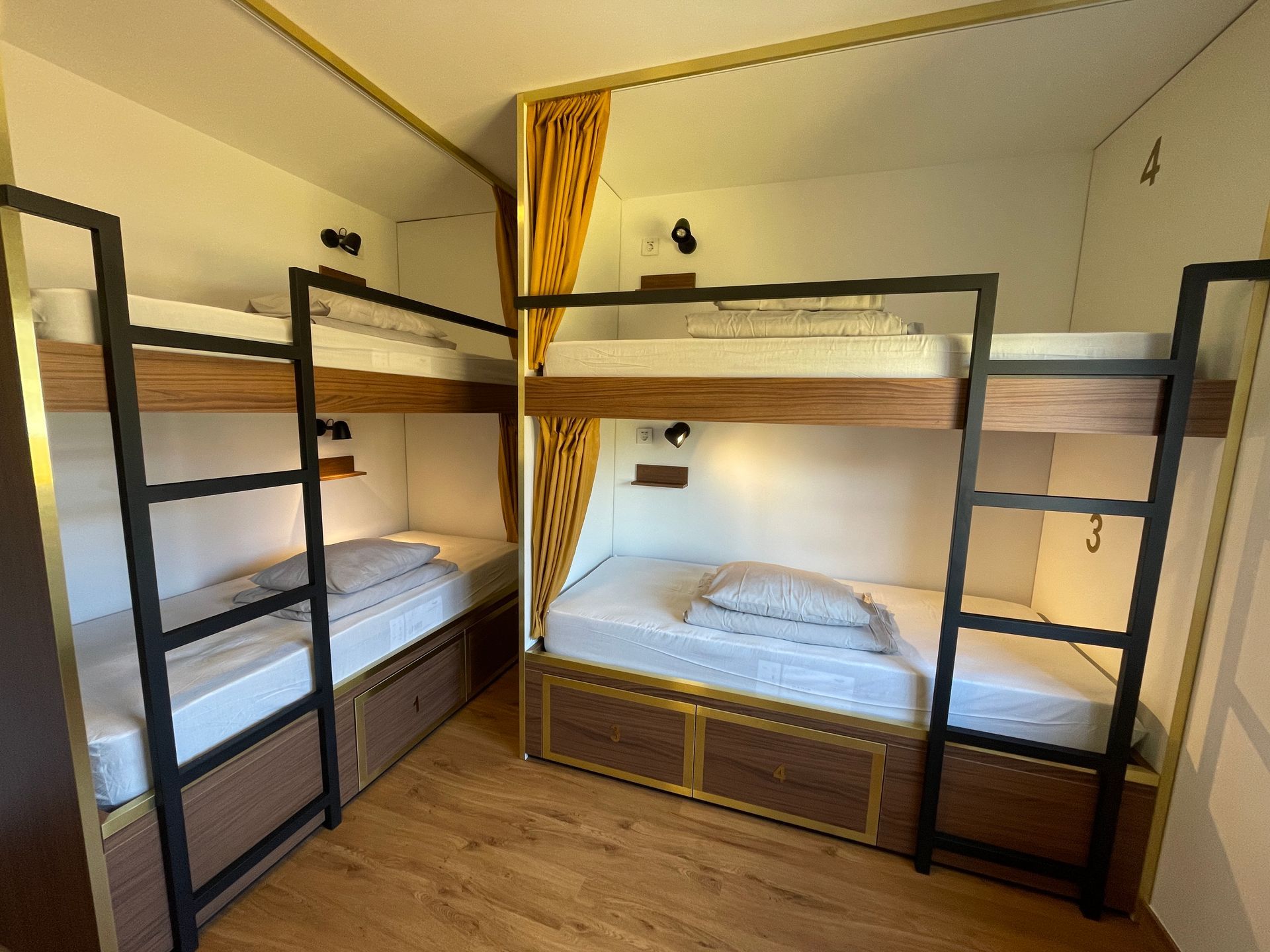 A room with four bunk beds and a ladder.