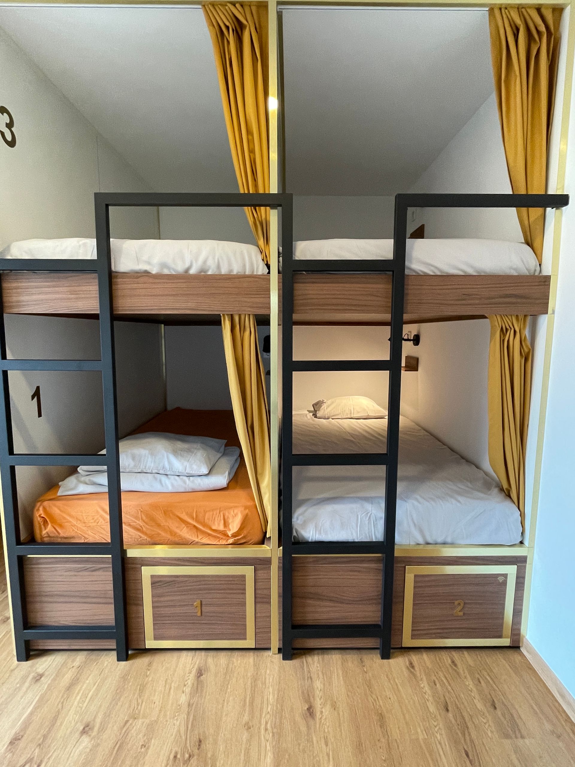 A bunk bed with the number 3 on the wall