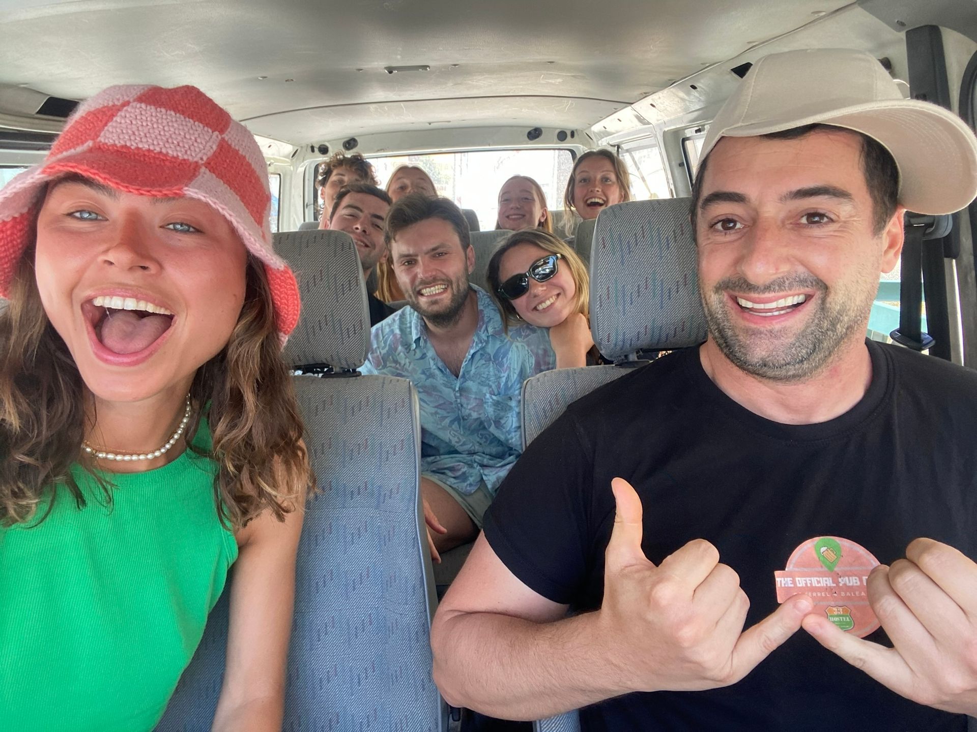 A group of people are sitting in the back of a van.