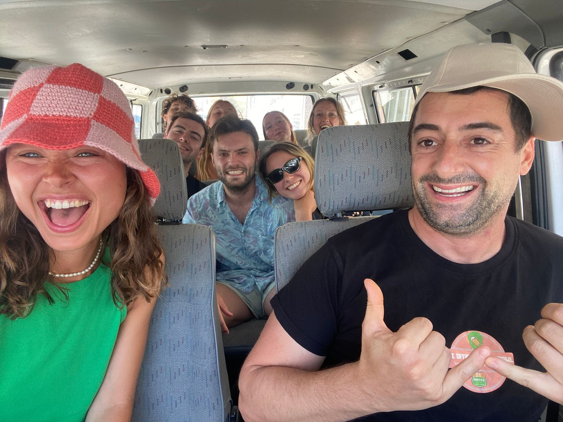 A group of people are sitting in the back of a van.