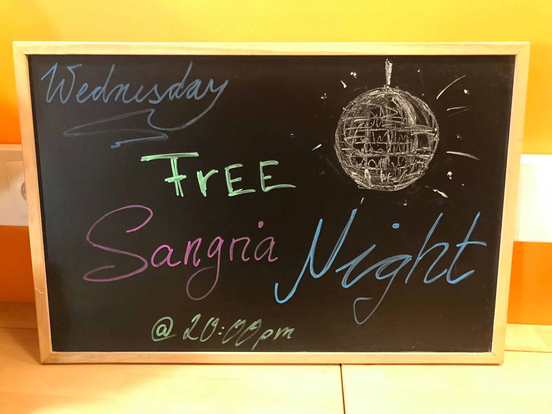 A chalkboard that says wednesday free sangria night