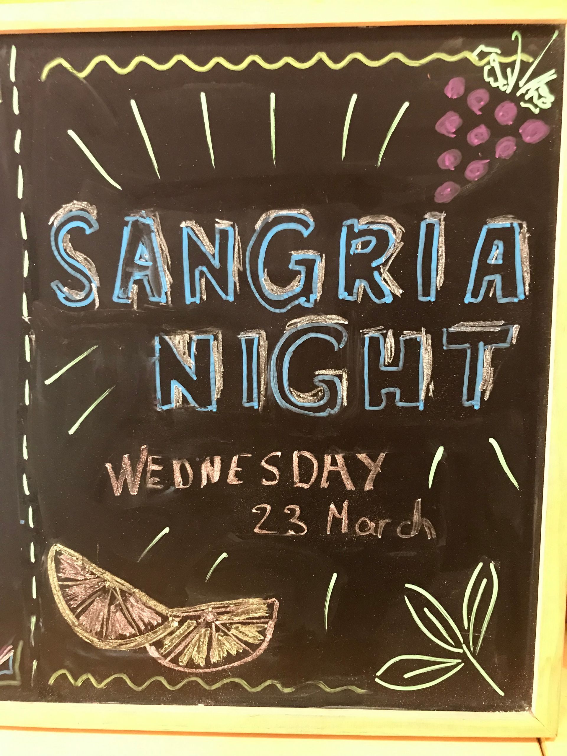 A chalkboard that says sangria night on it