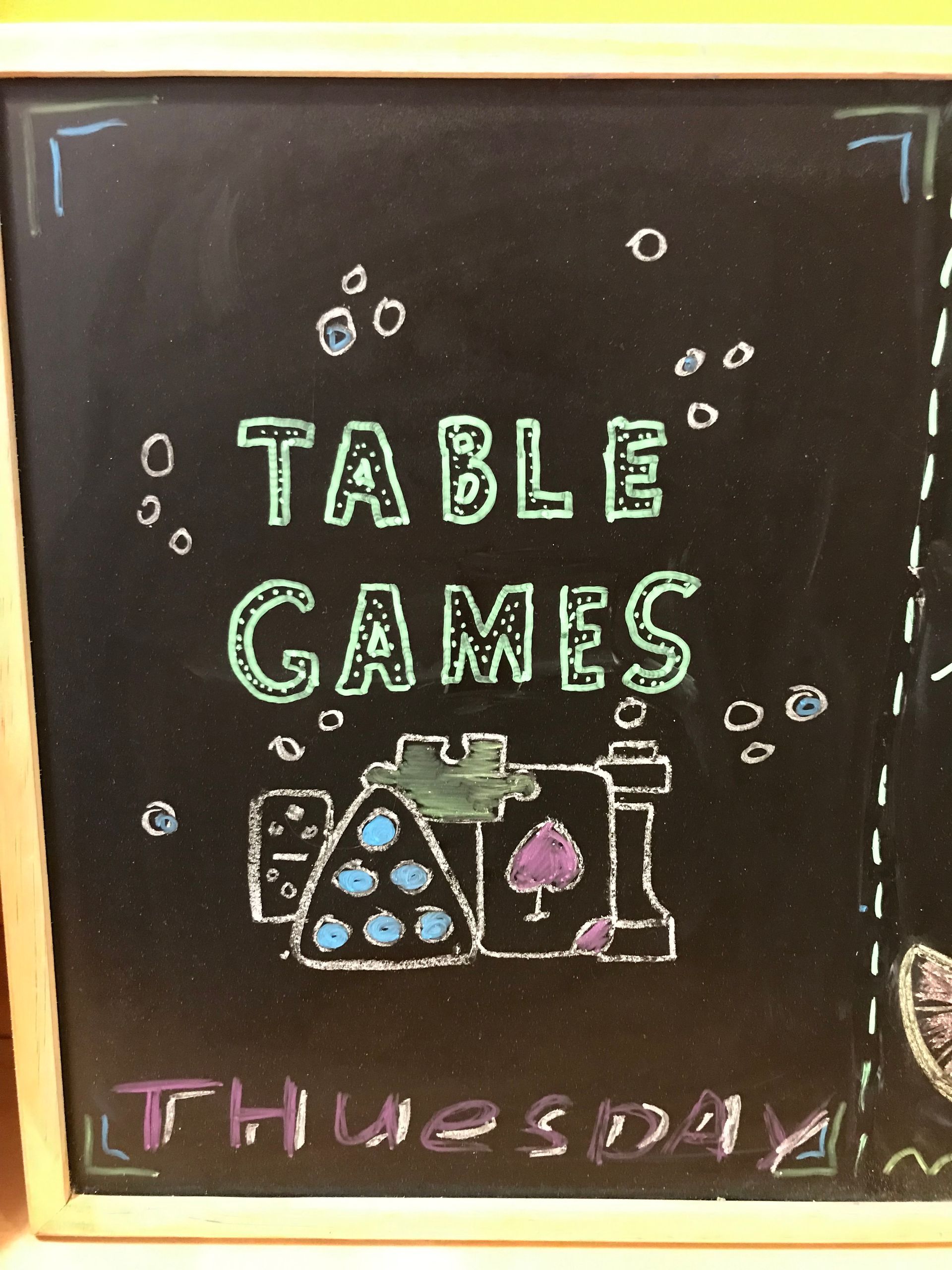 A blackboard with the words table games written on it