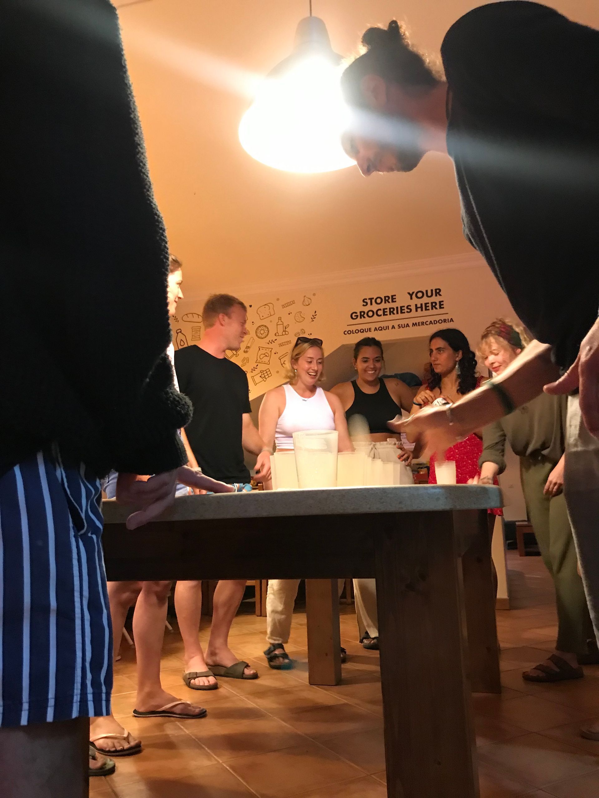 A group of people are standing around a table in a room.