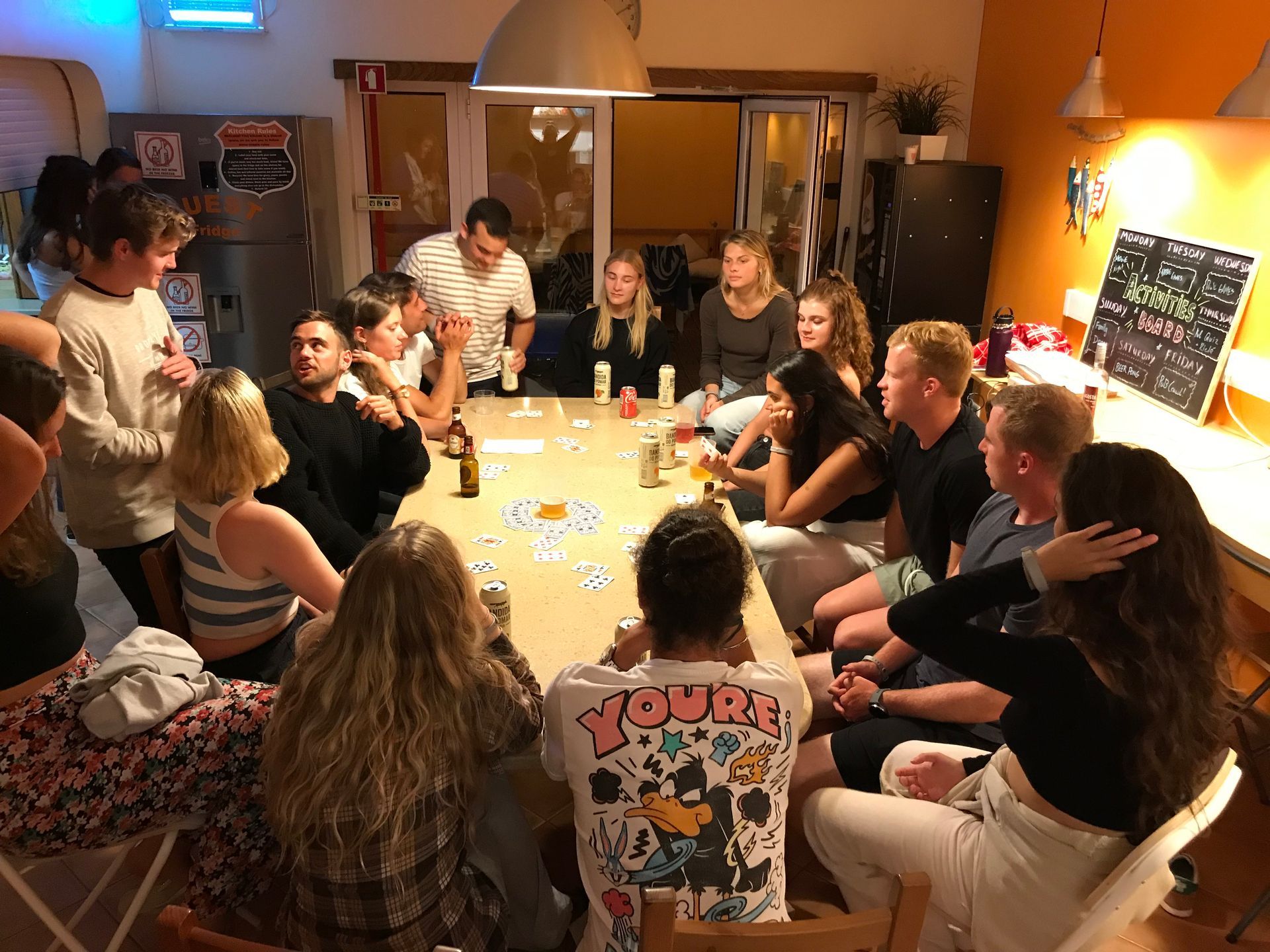 A group of people are sitting around a table in a room.