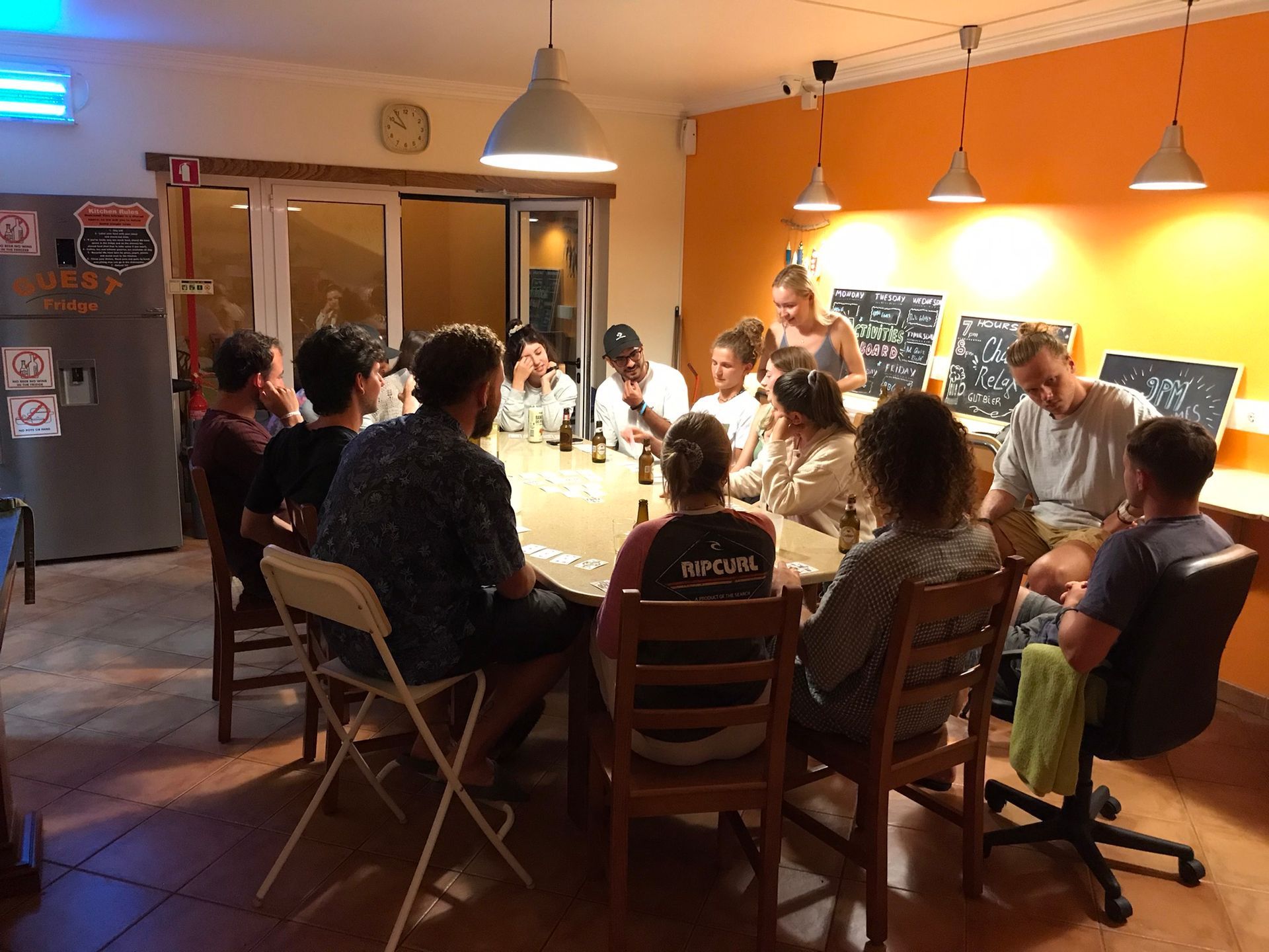 A group of people are sitting around a table in a room.