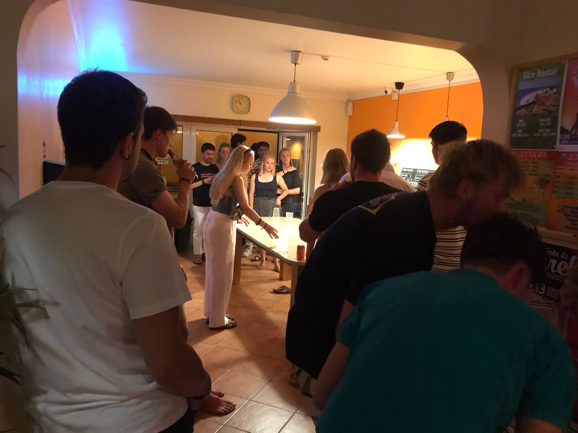 A group of people standing in a room with a sign that says ' agave ' on it