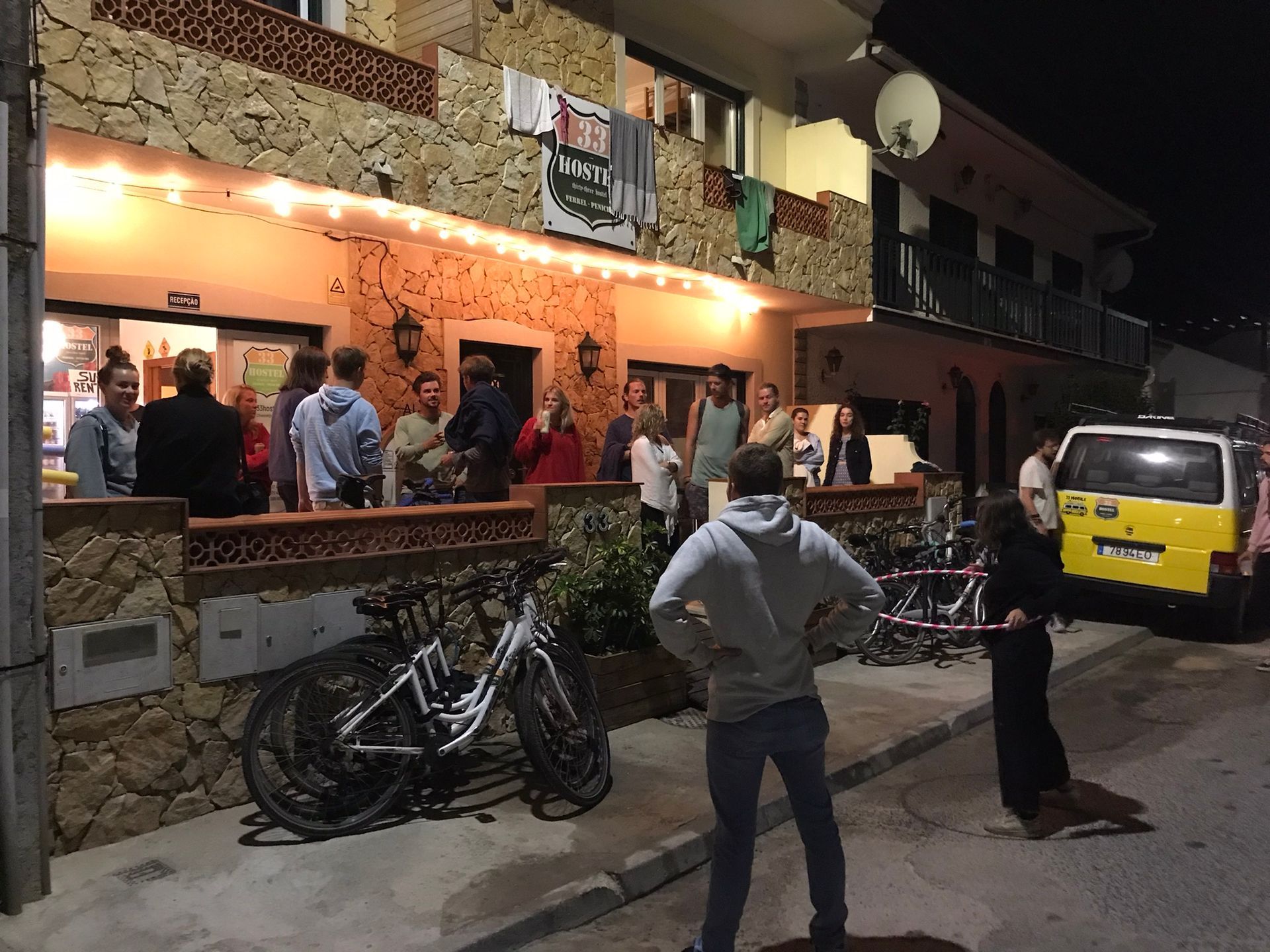 A group of people are standing outside of a building at night