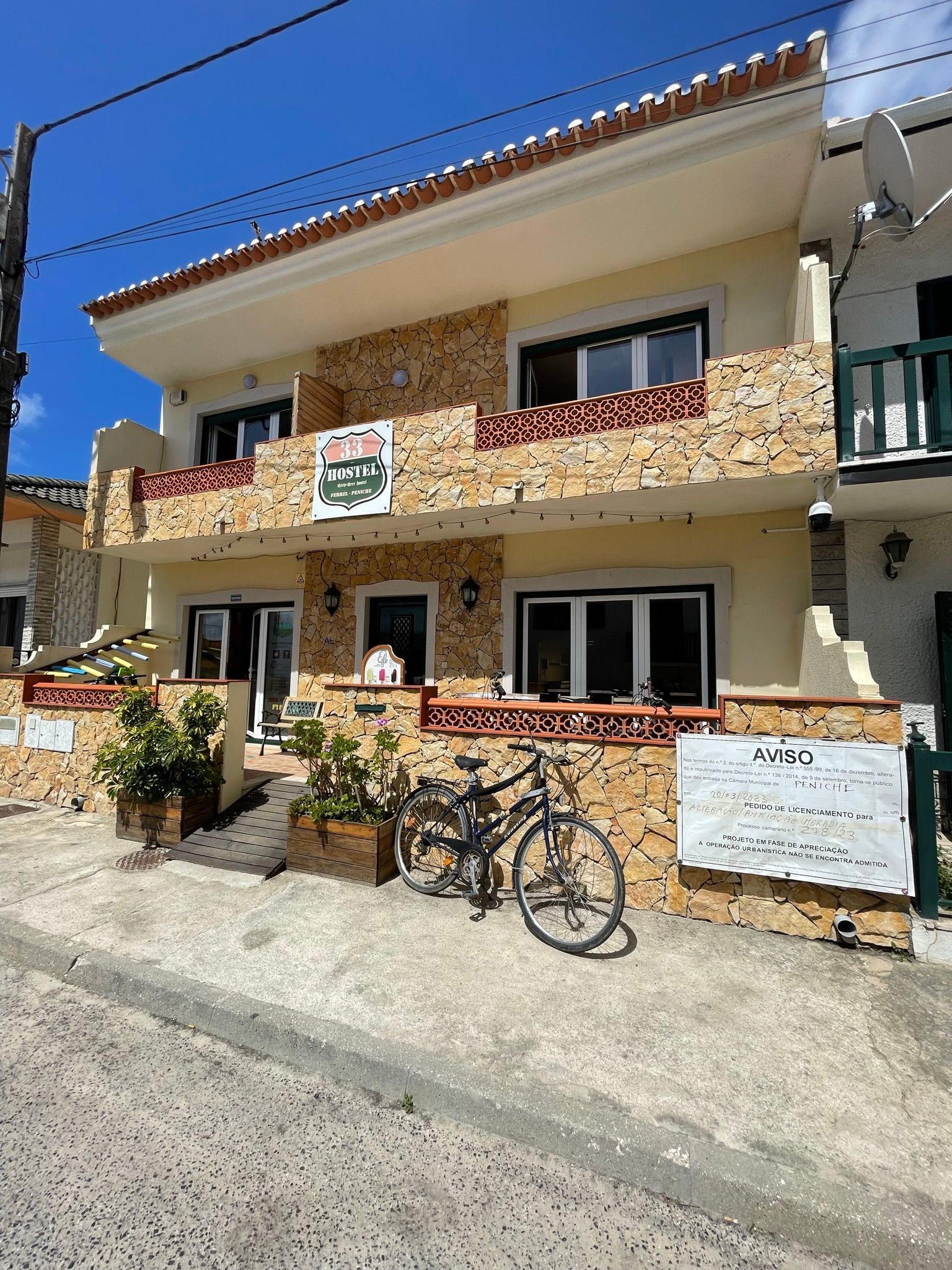 A bicycle is parked in front of a large house.