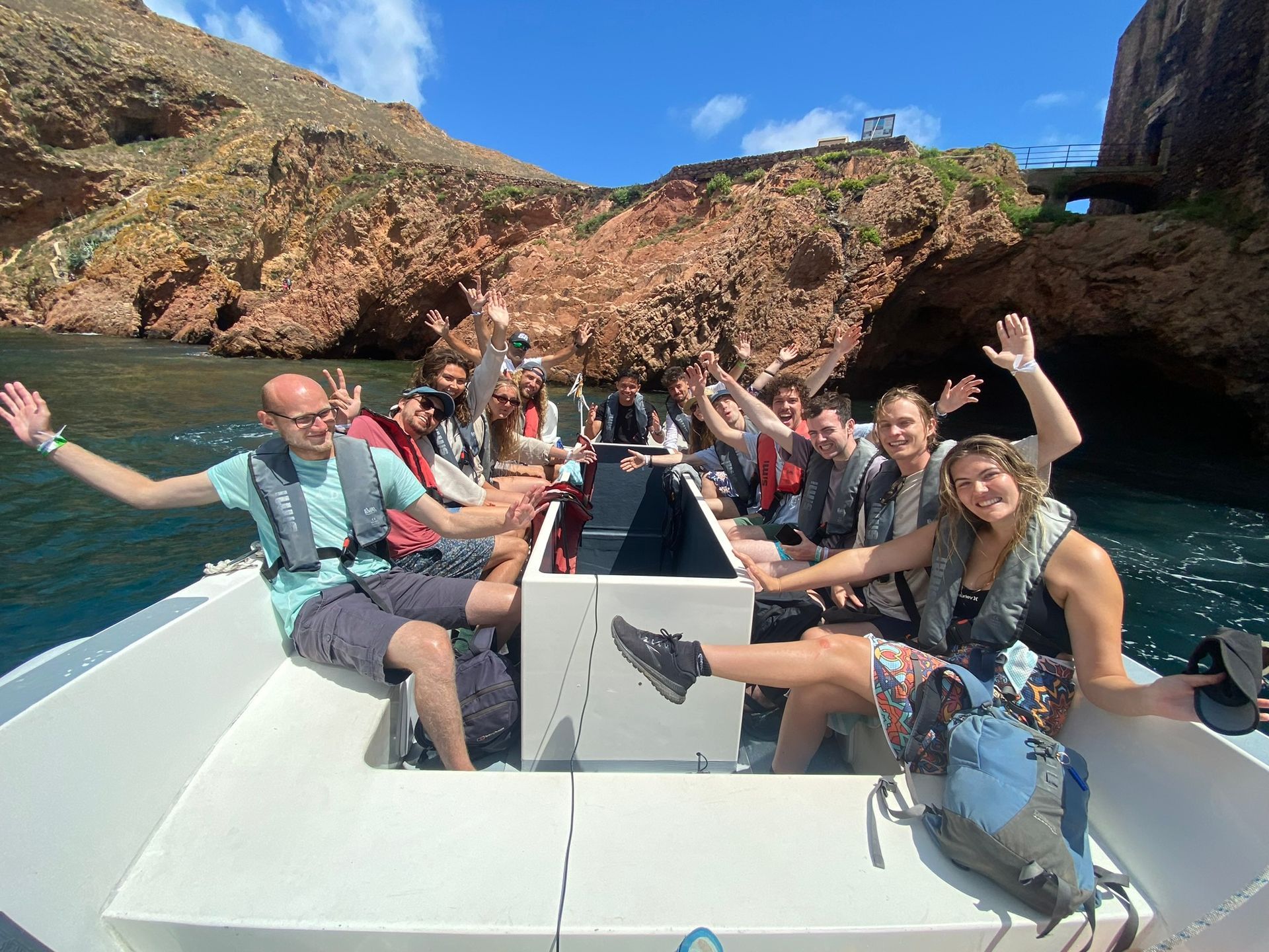 A group of people are sitting on a boat in the ocean.