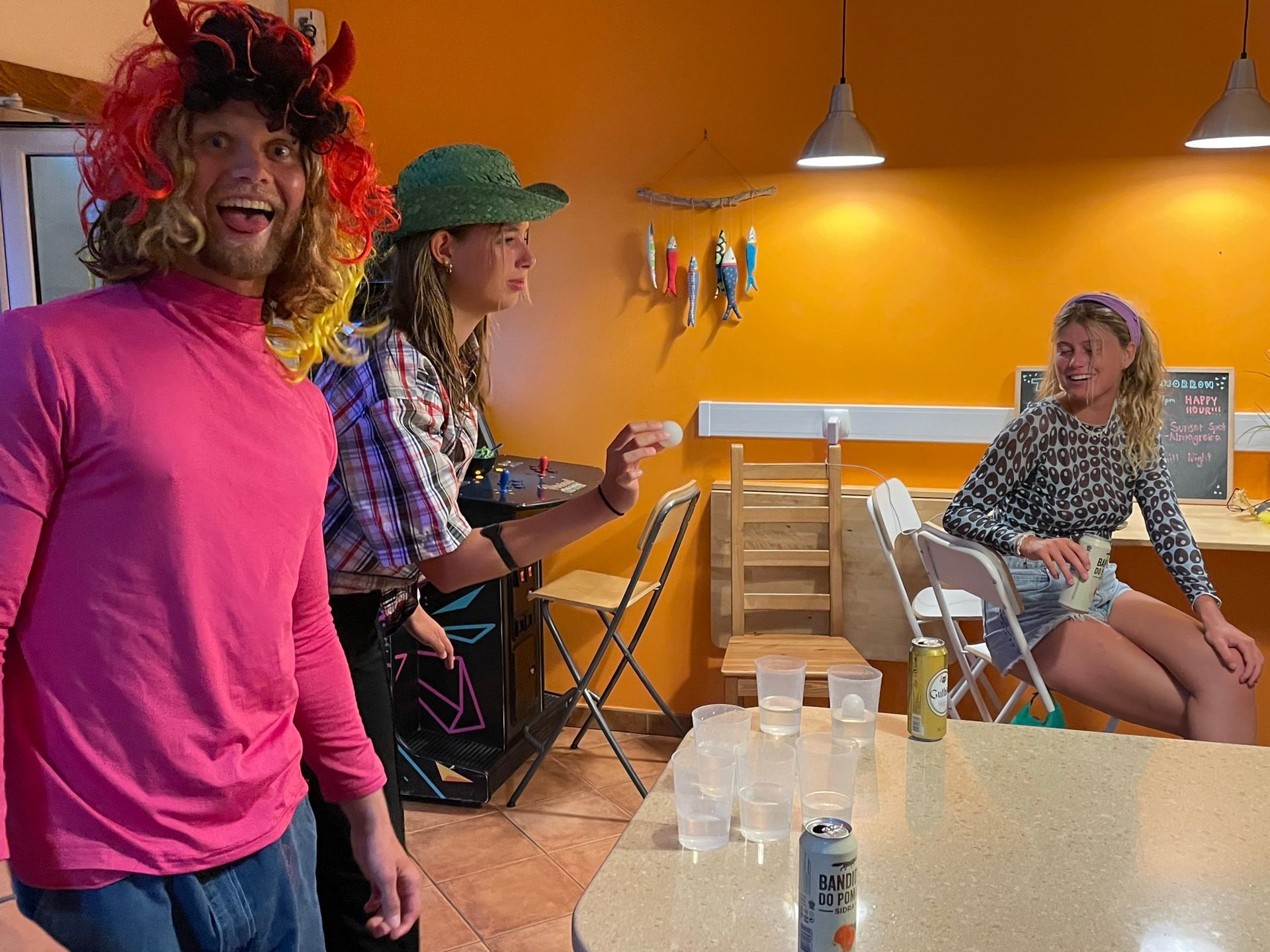 A group of people are standing around a table in a room.