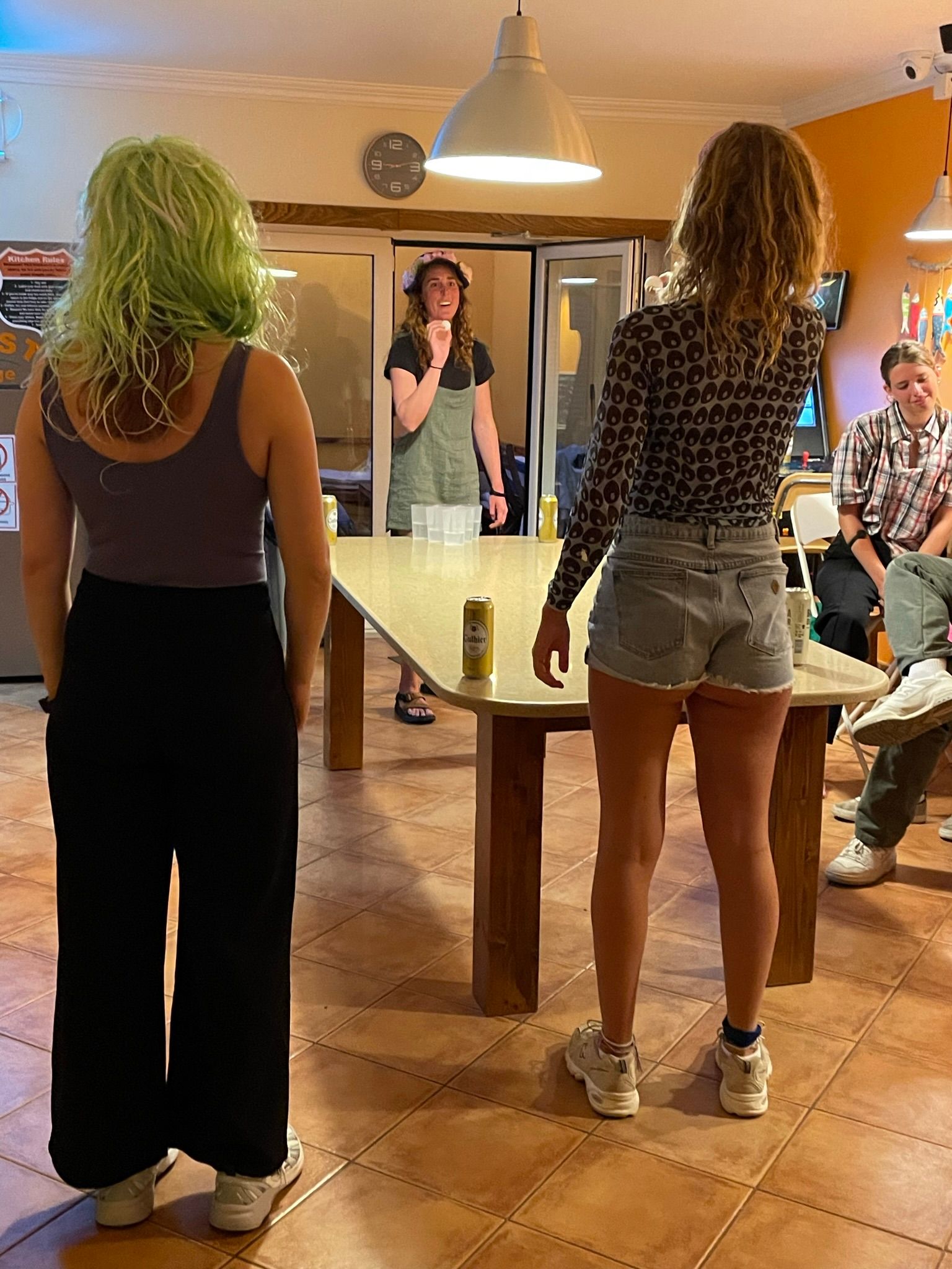 A group of people are standing around a table in a room.