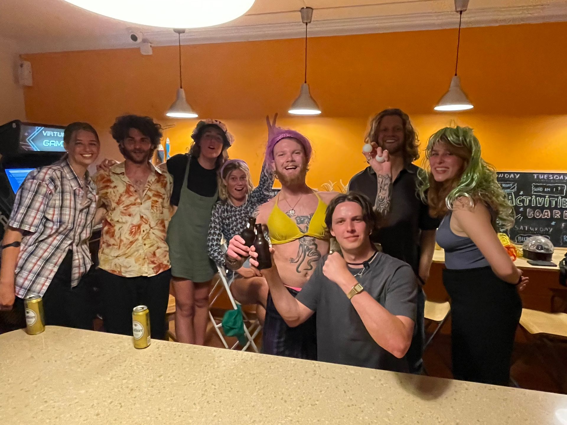 A group of people are posing for a picture at a bar.