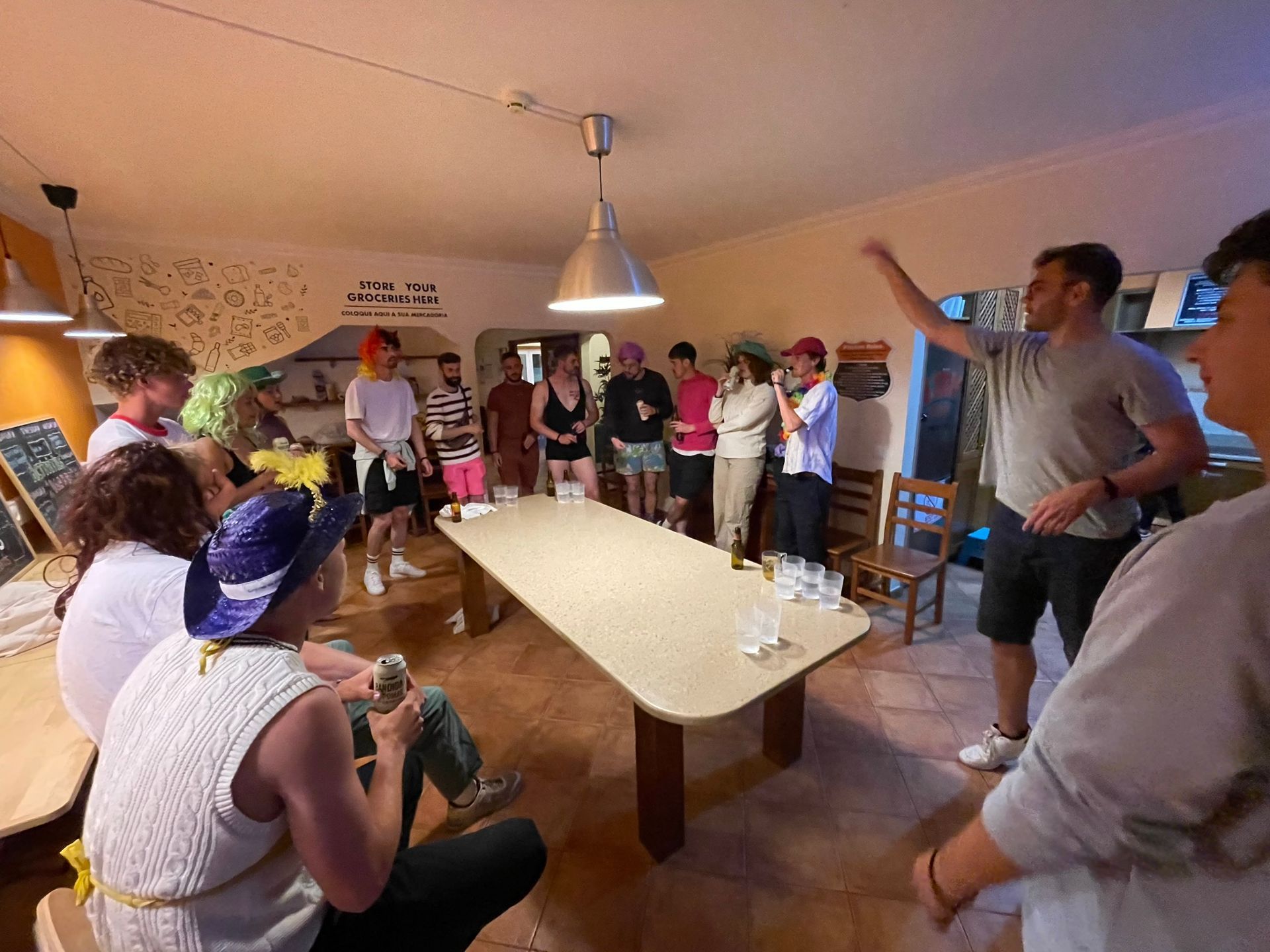 A group of people are sitting around a long table in a room.