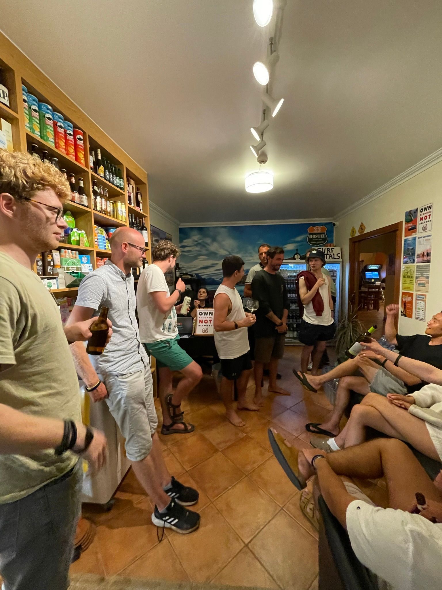 A group of people are standing and sitting in a room.