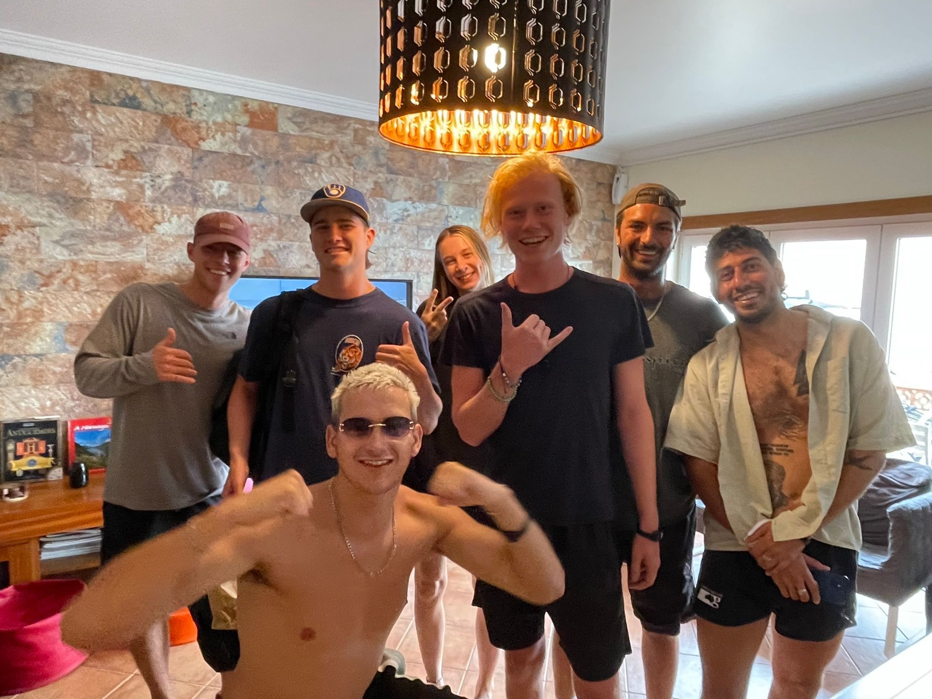 A group of people are posing for a picture in a living room.