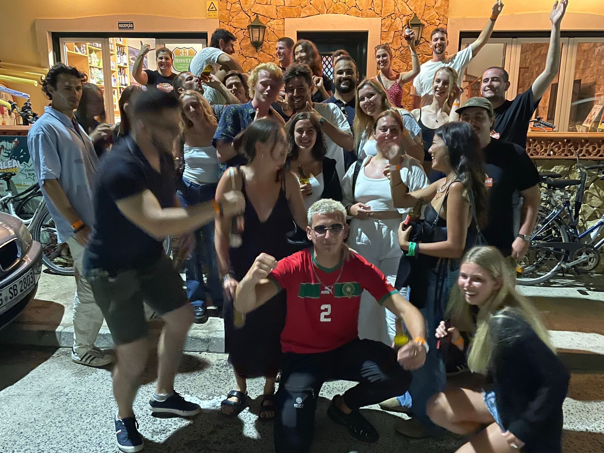 A group of people are posing for a picture in front of a building.