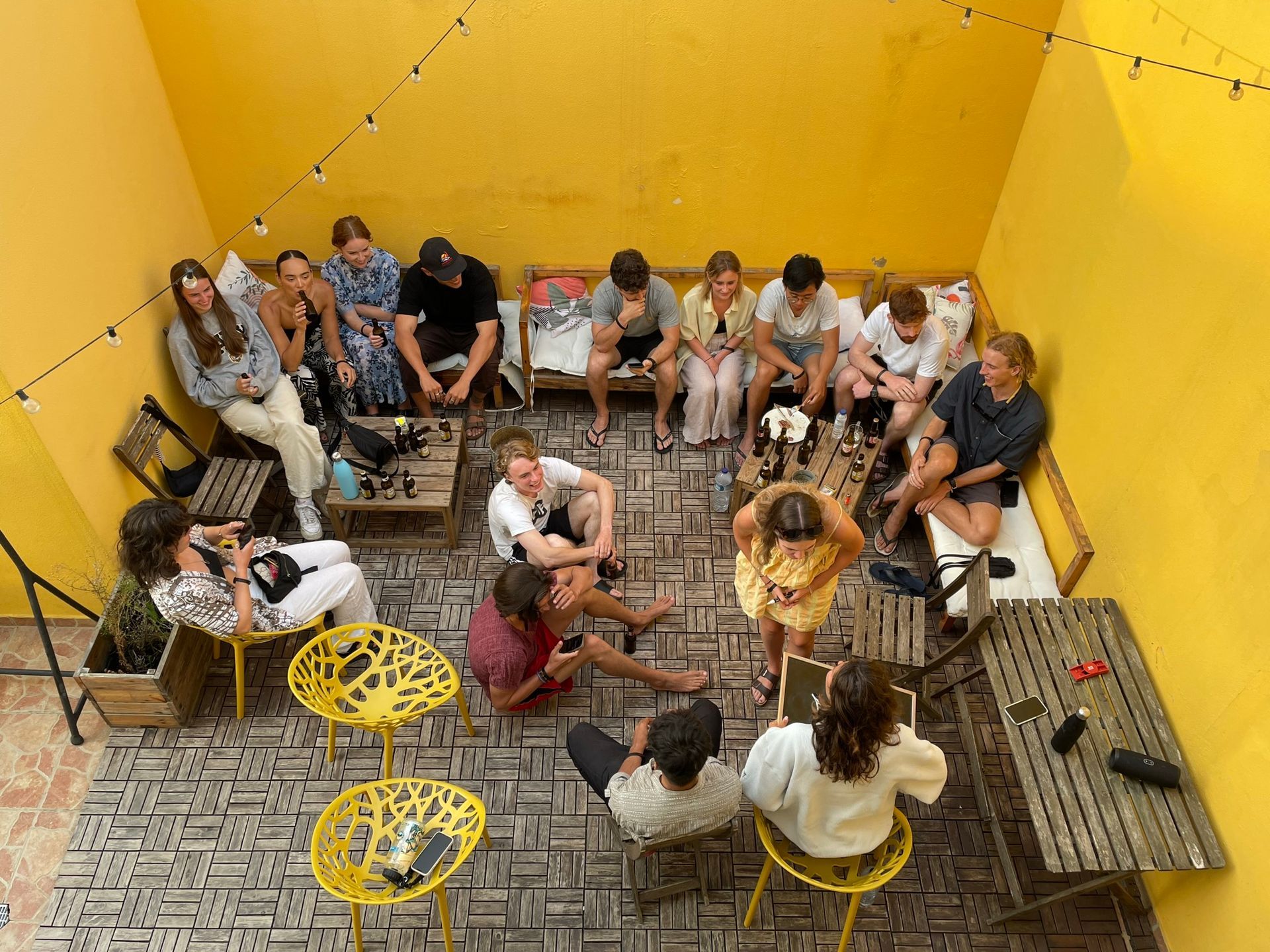 A group of people are sitting in a circle on a patio.
