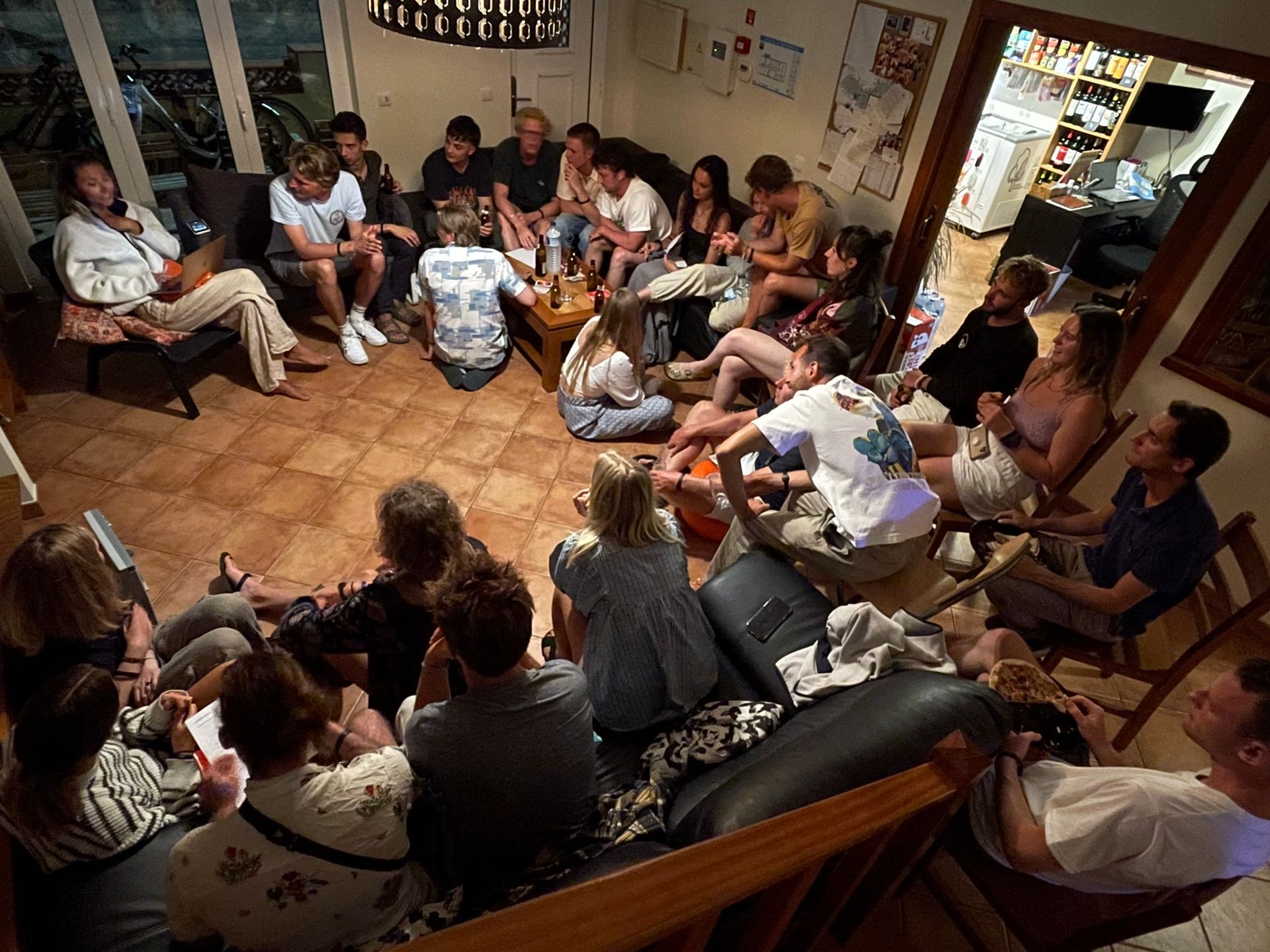A group of people are sitting in a circle in a living room.
