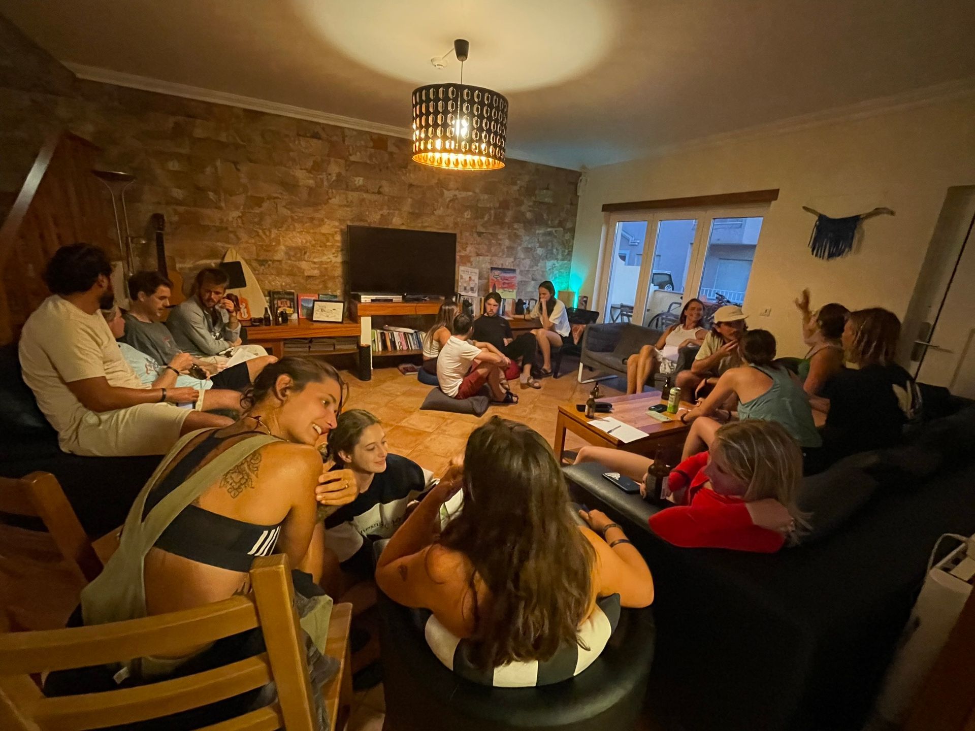 A group of people are sitting in a circle in a living room.
