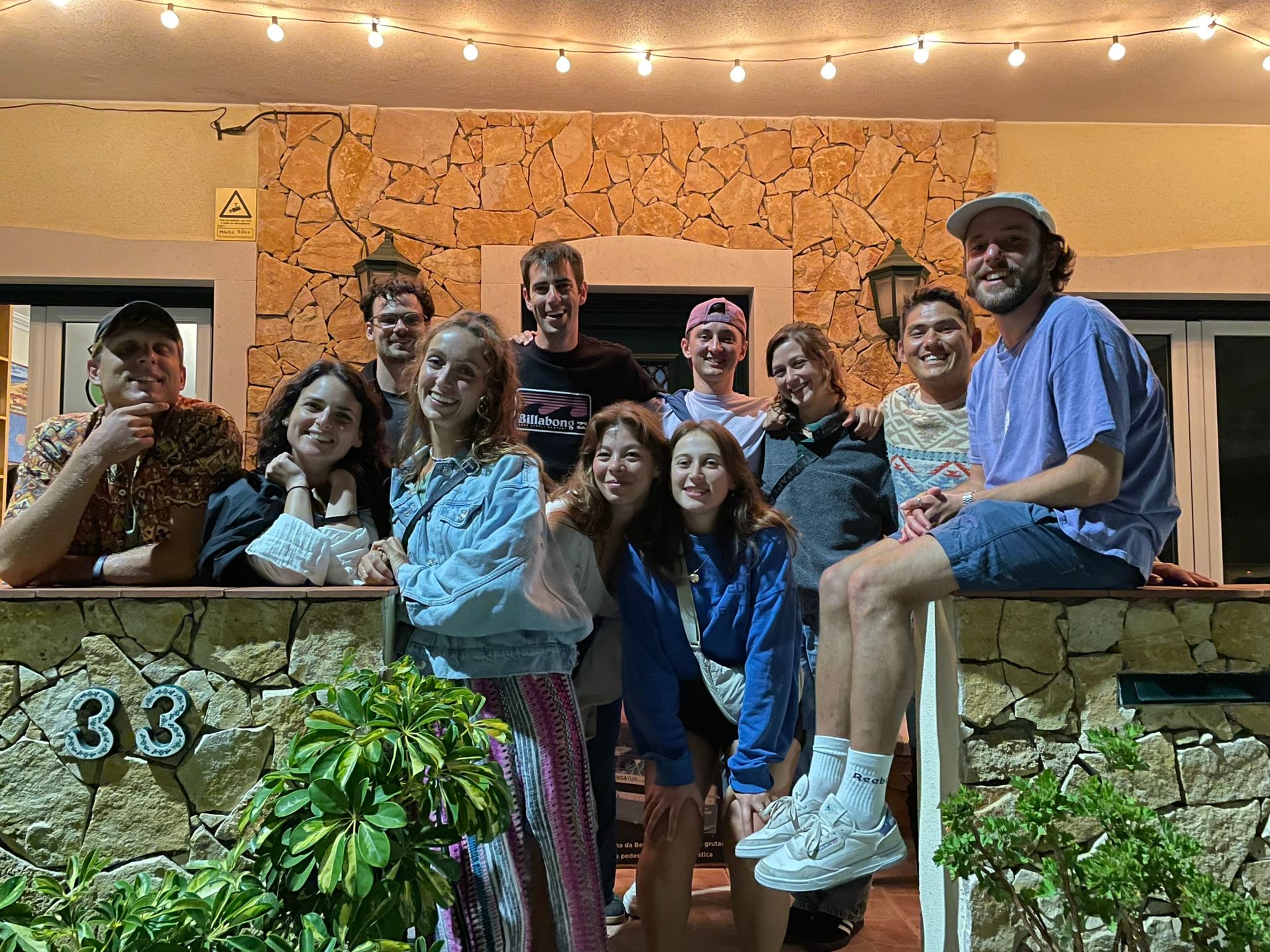 A group of people are posing for a picture in front of a building.