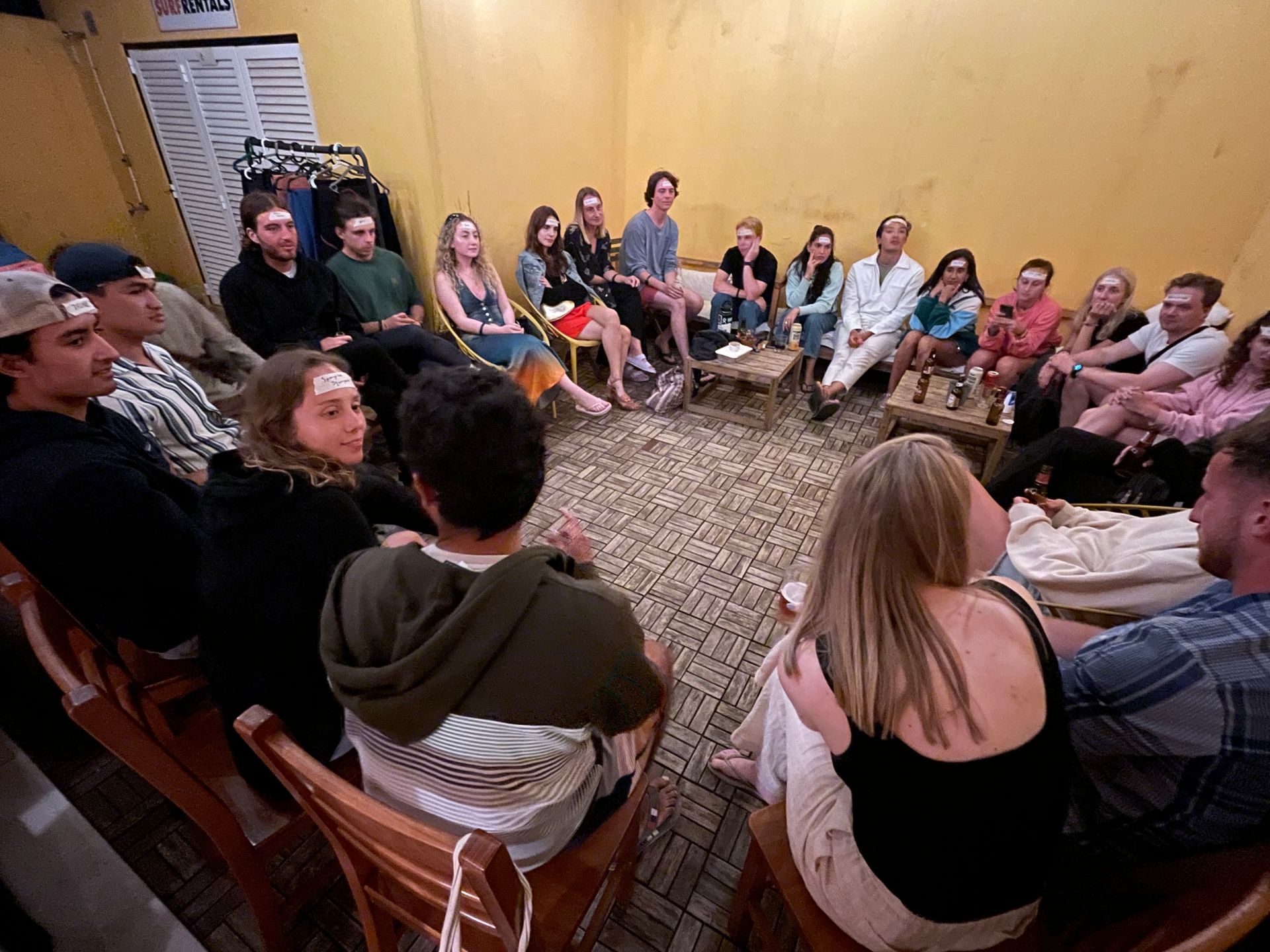 A group of people are sitting in a circle in a room.