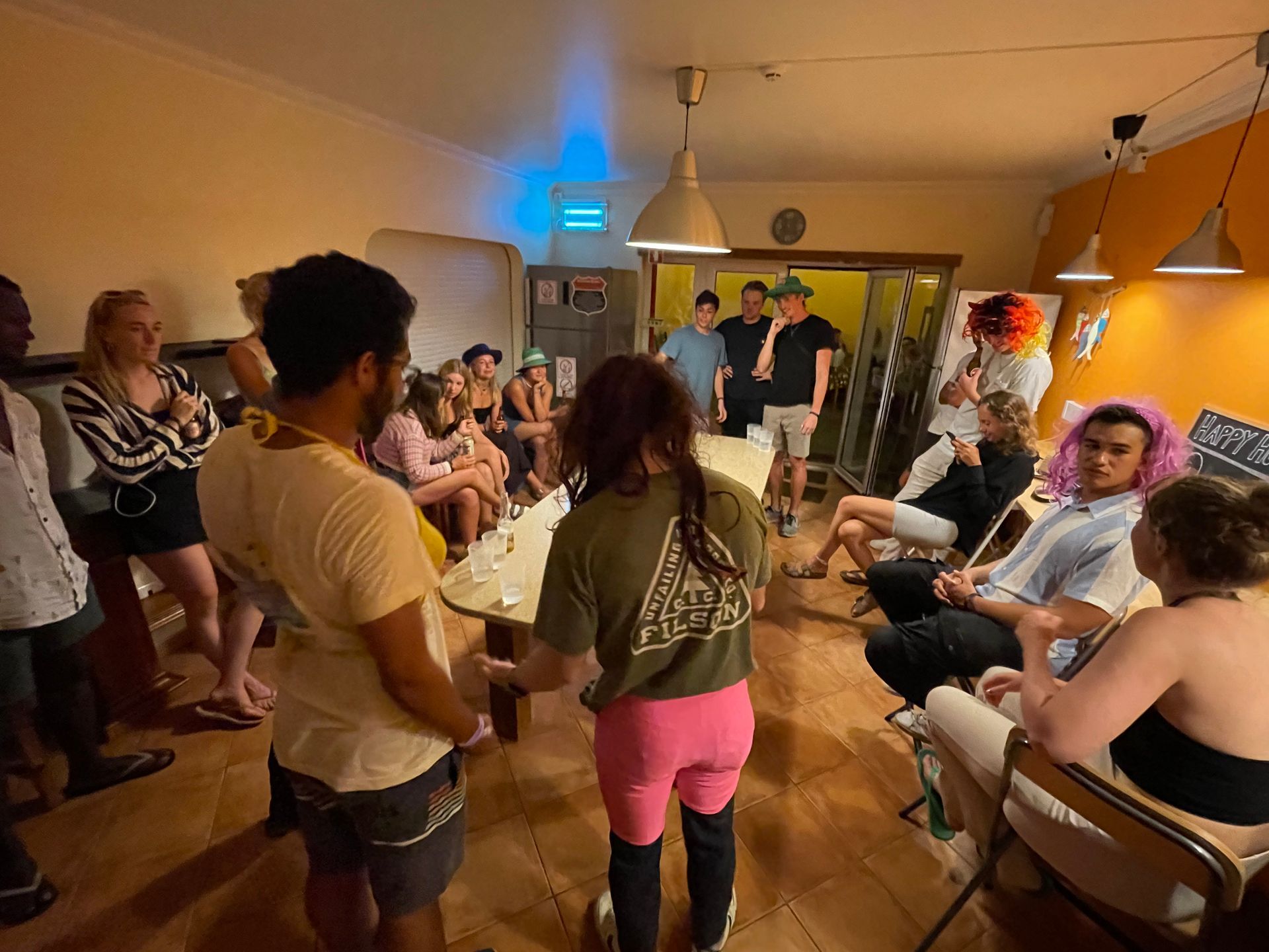 A group of people are standing around a table in a room.