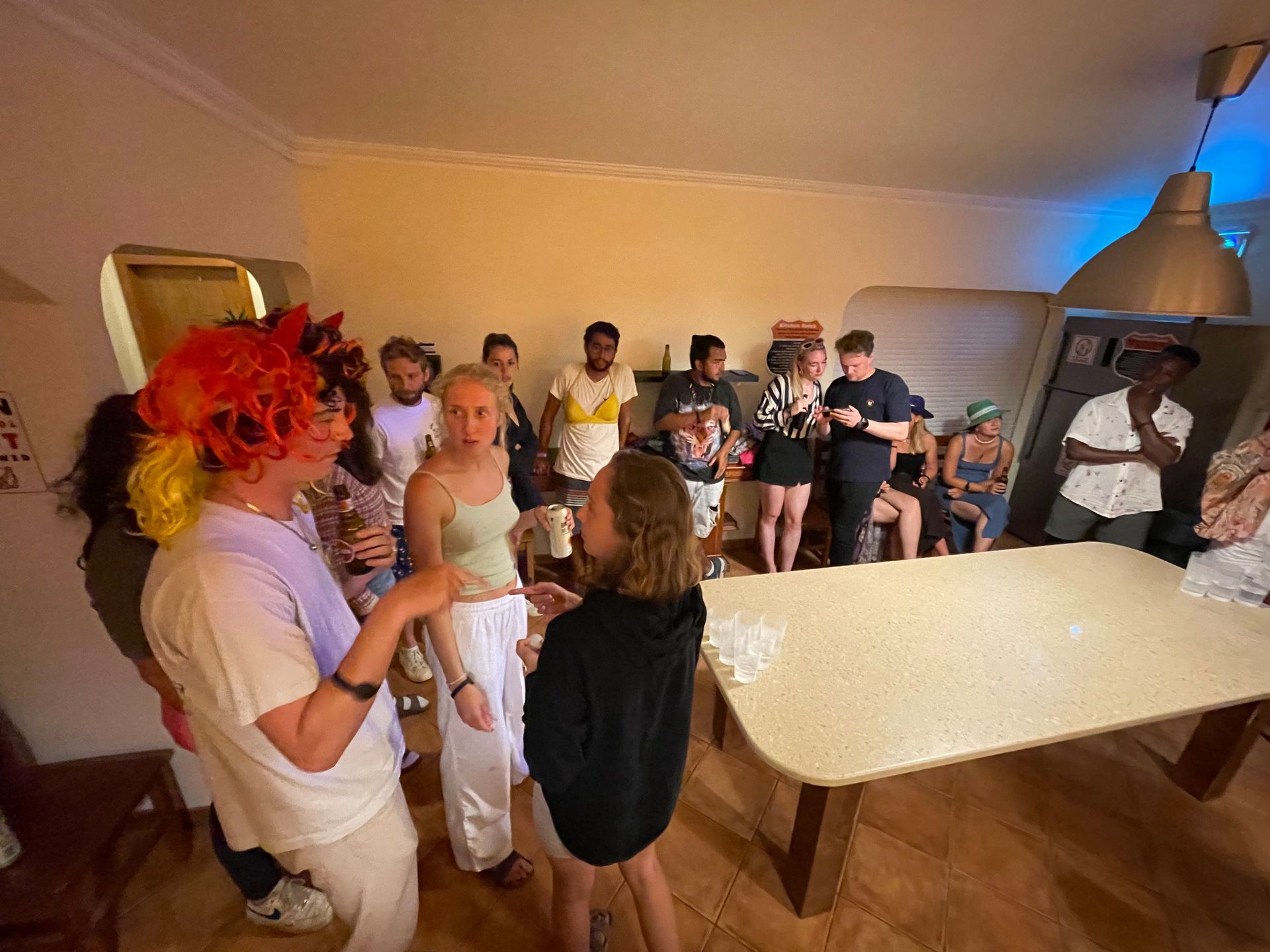 A group of people are standing around a table in a room.