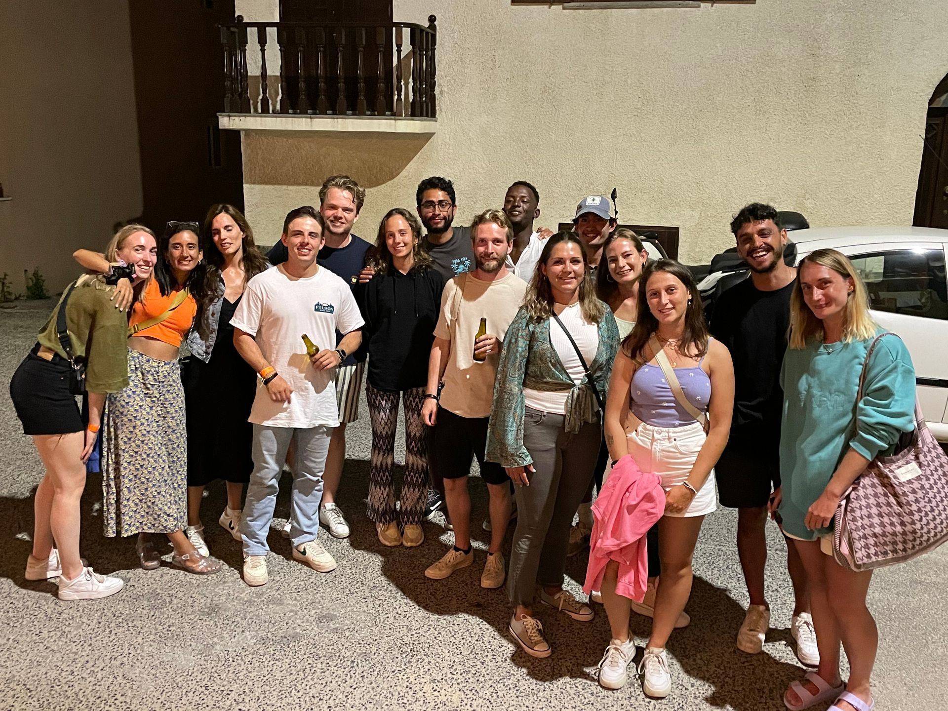 A group of people are posing for a picture in front of a building.