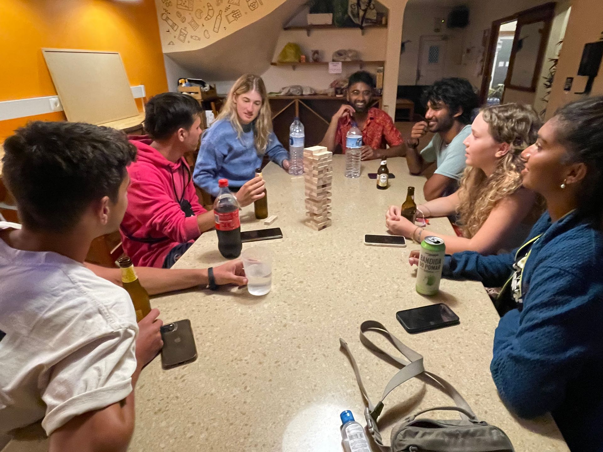 A group of people are sitting around a table playing a game.