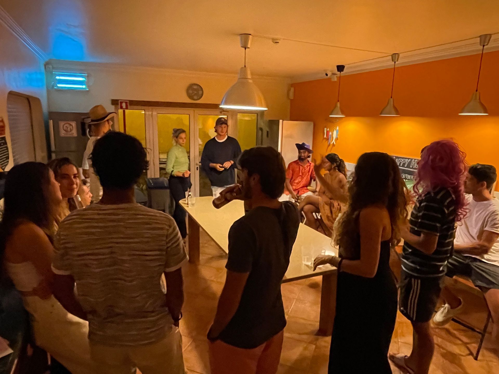 A group of people are standing around a table in a room.