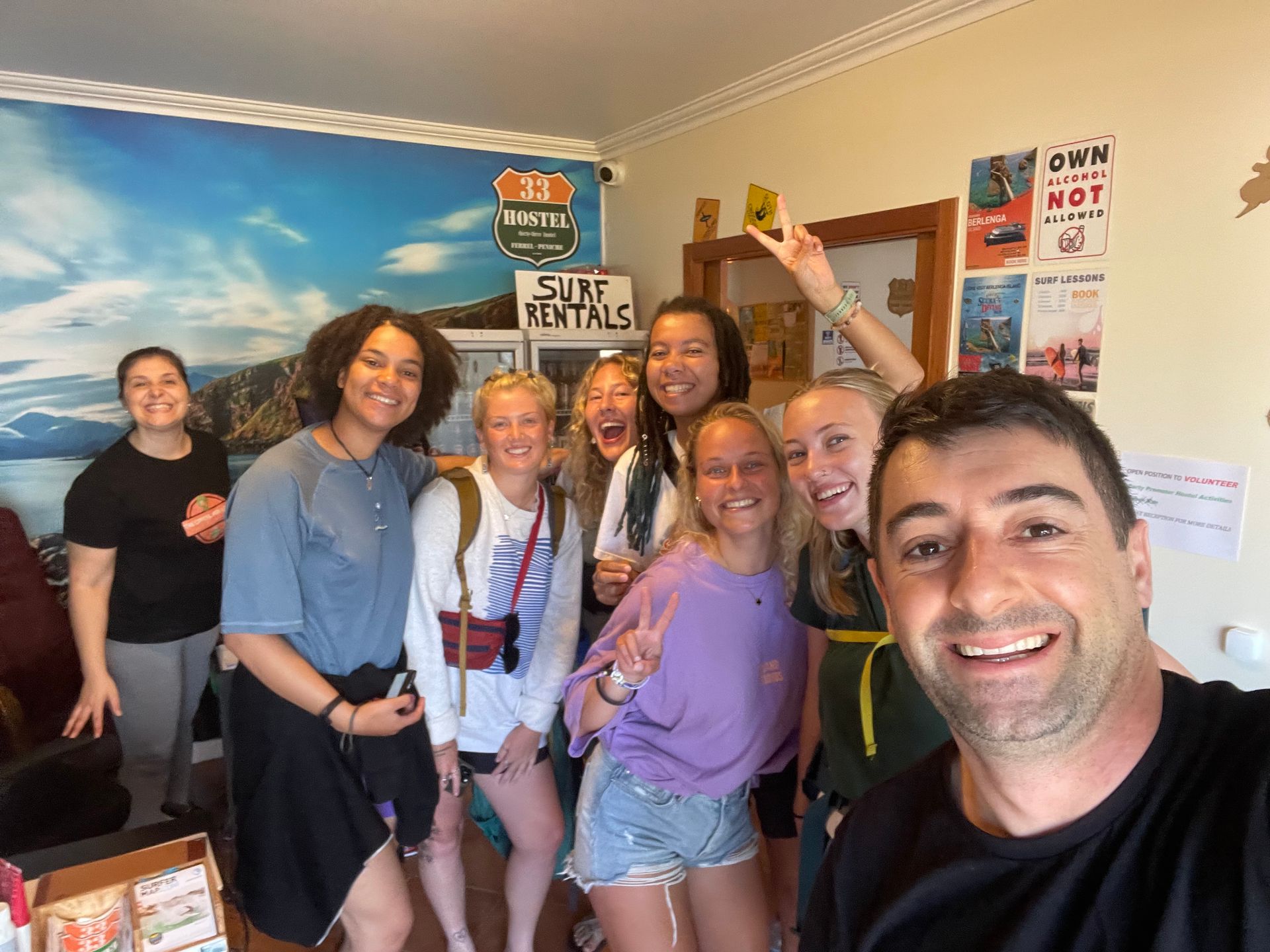 A group of people are posing for a picture in a room.