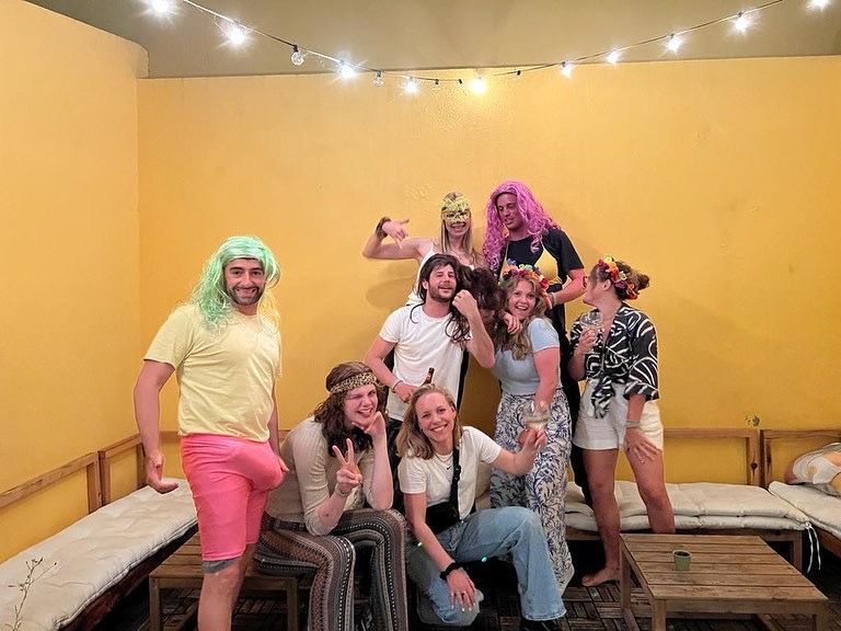 A group of people are posing for a picture in a room.