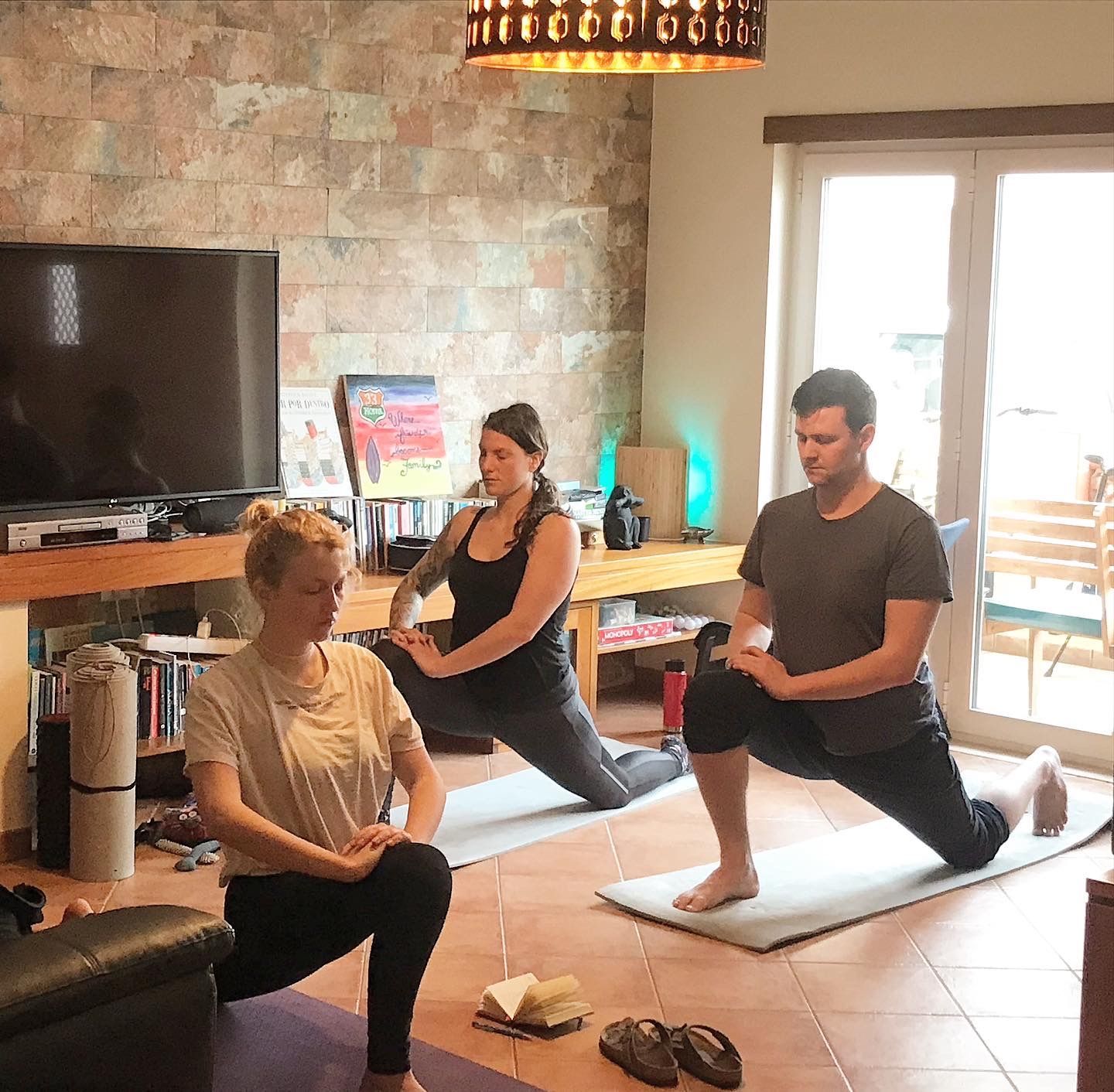 A group of people are doing yoga in a living room