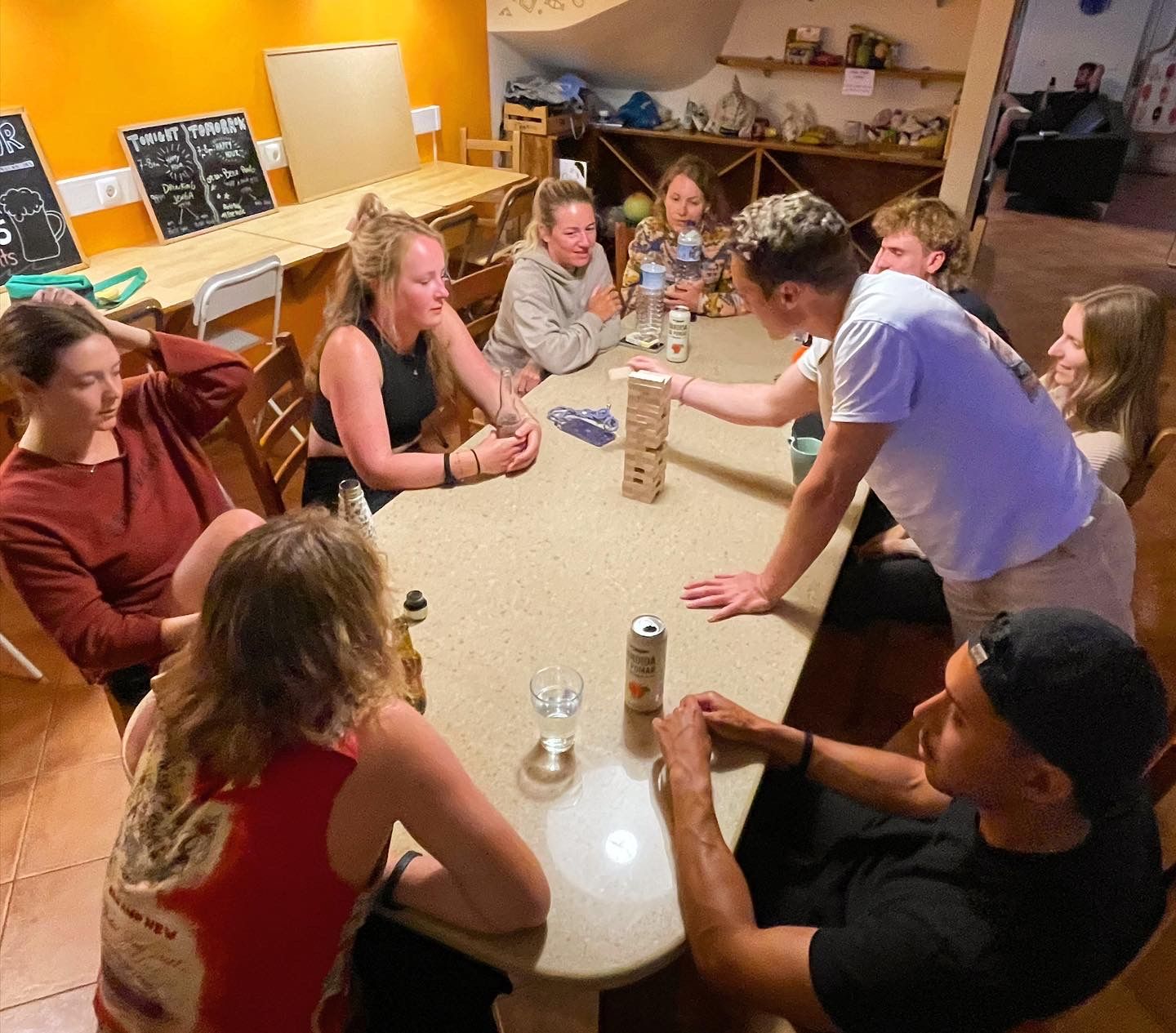 A group of people are sitting around a table playing a game.