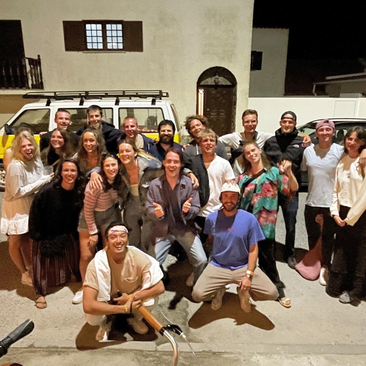 A group of people posing for a picture in front of a building