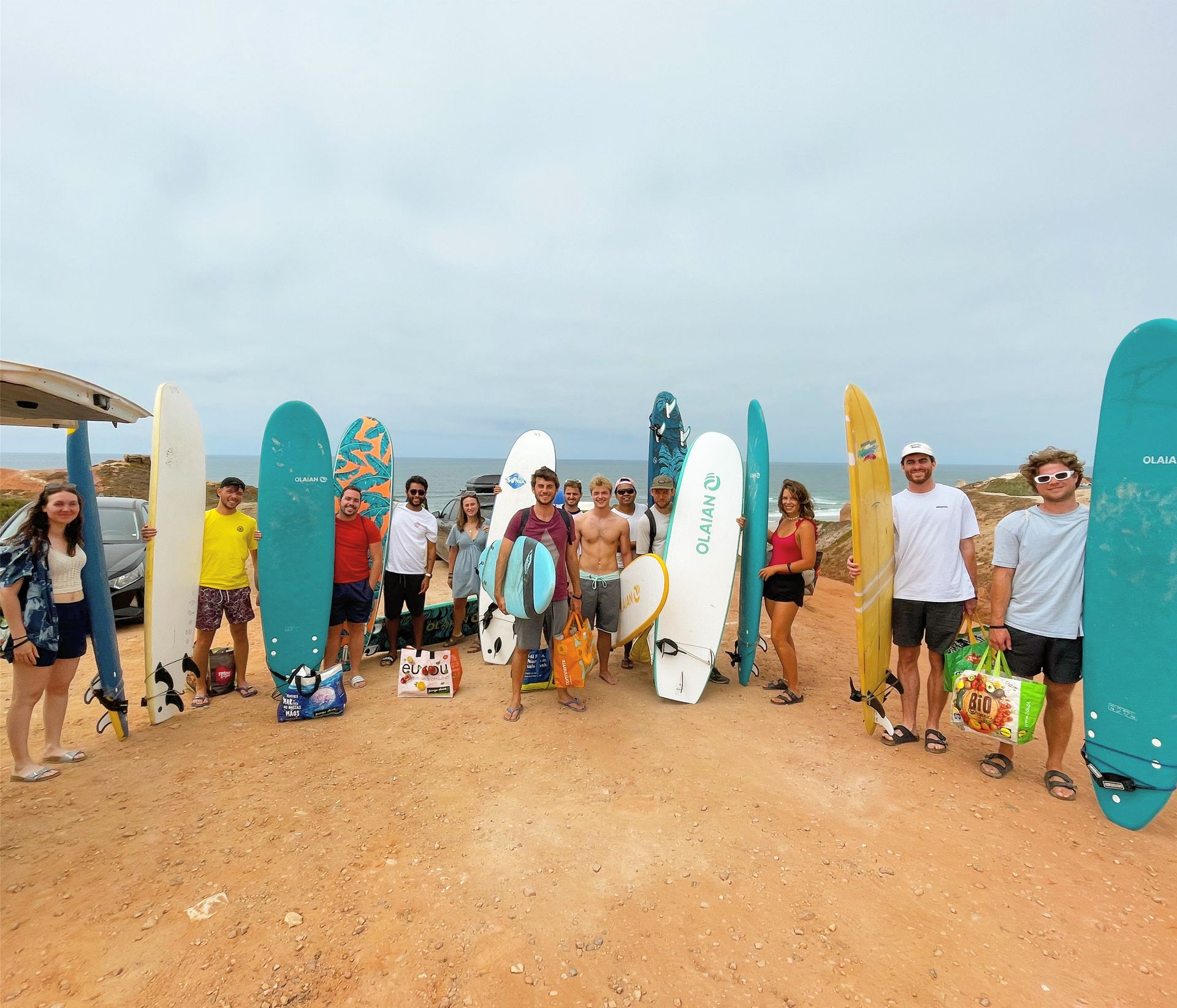 A group of people standing next to surfboards including one that says ' o'neill ' on it
