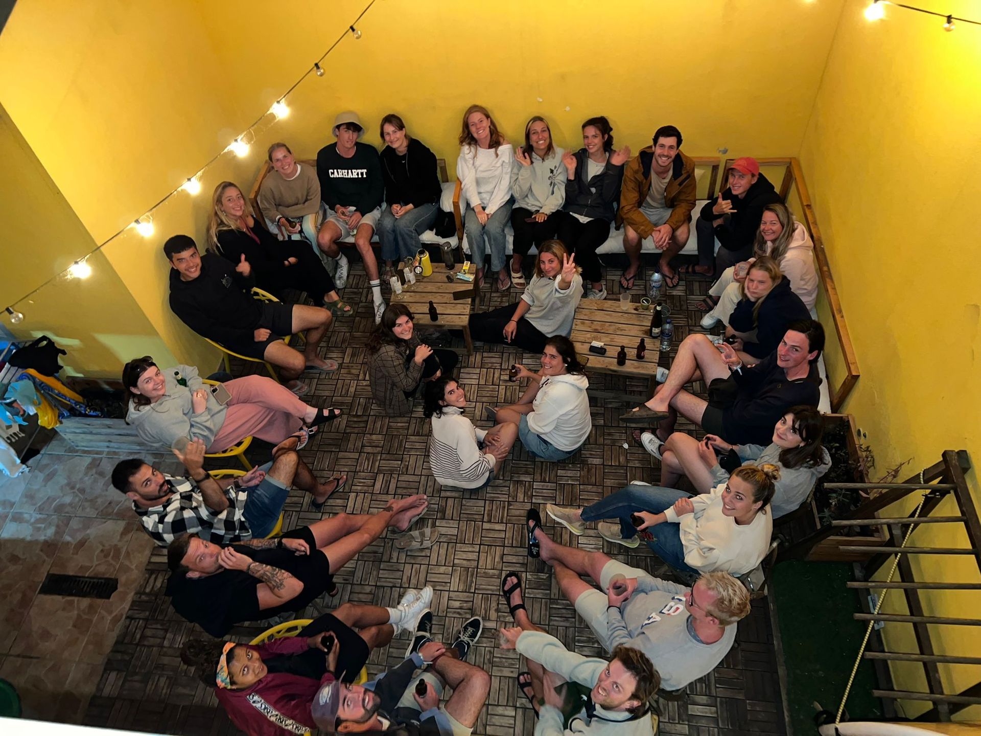 A group of people are sitting in a circle on the floor.