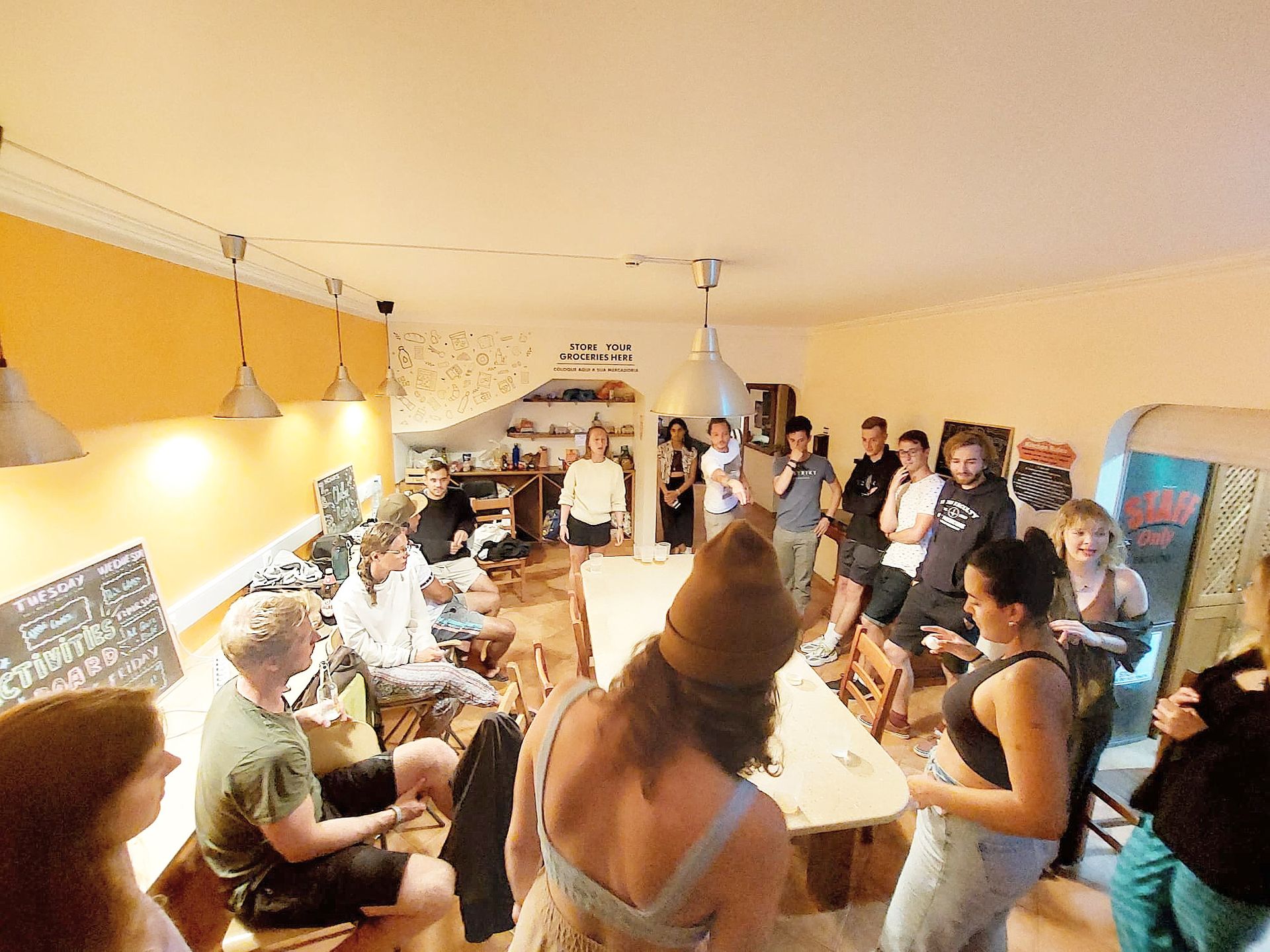 A group of people are standing around a table in a room.