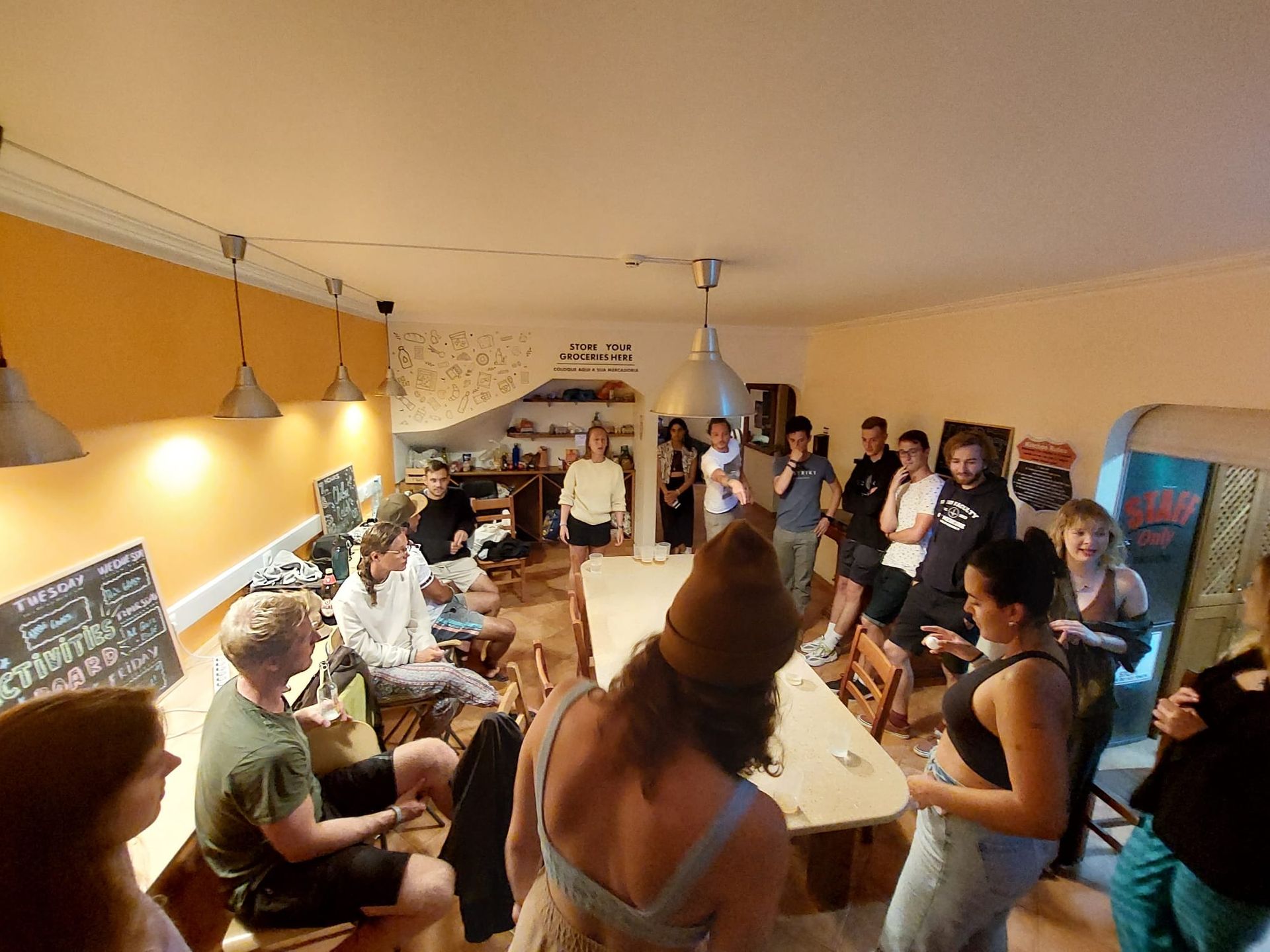 A group of people are standing around a table in a room.